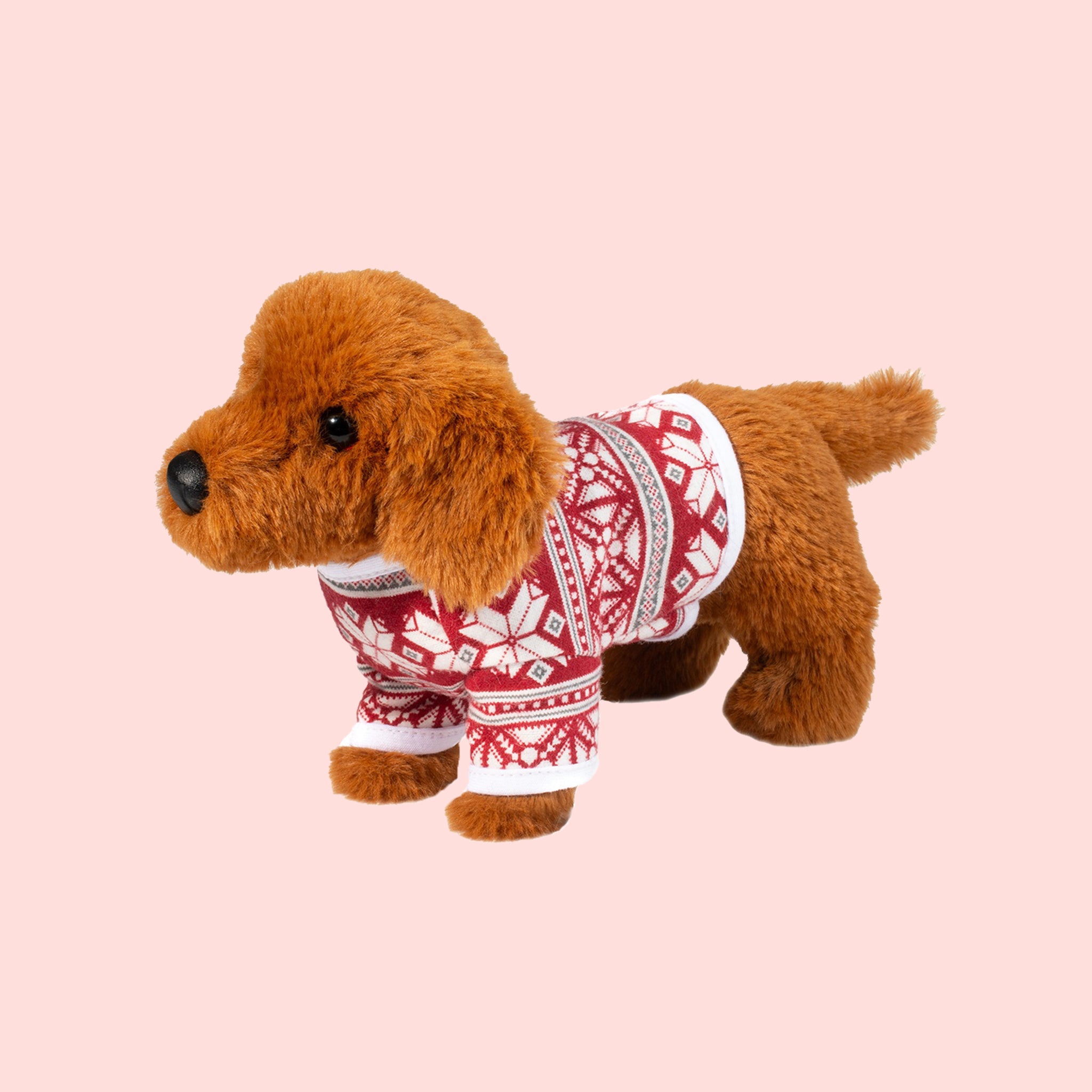 A mini brown dachshund shaped stuffed animal wearing a red and white holiday sweater. 