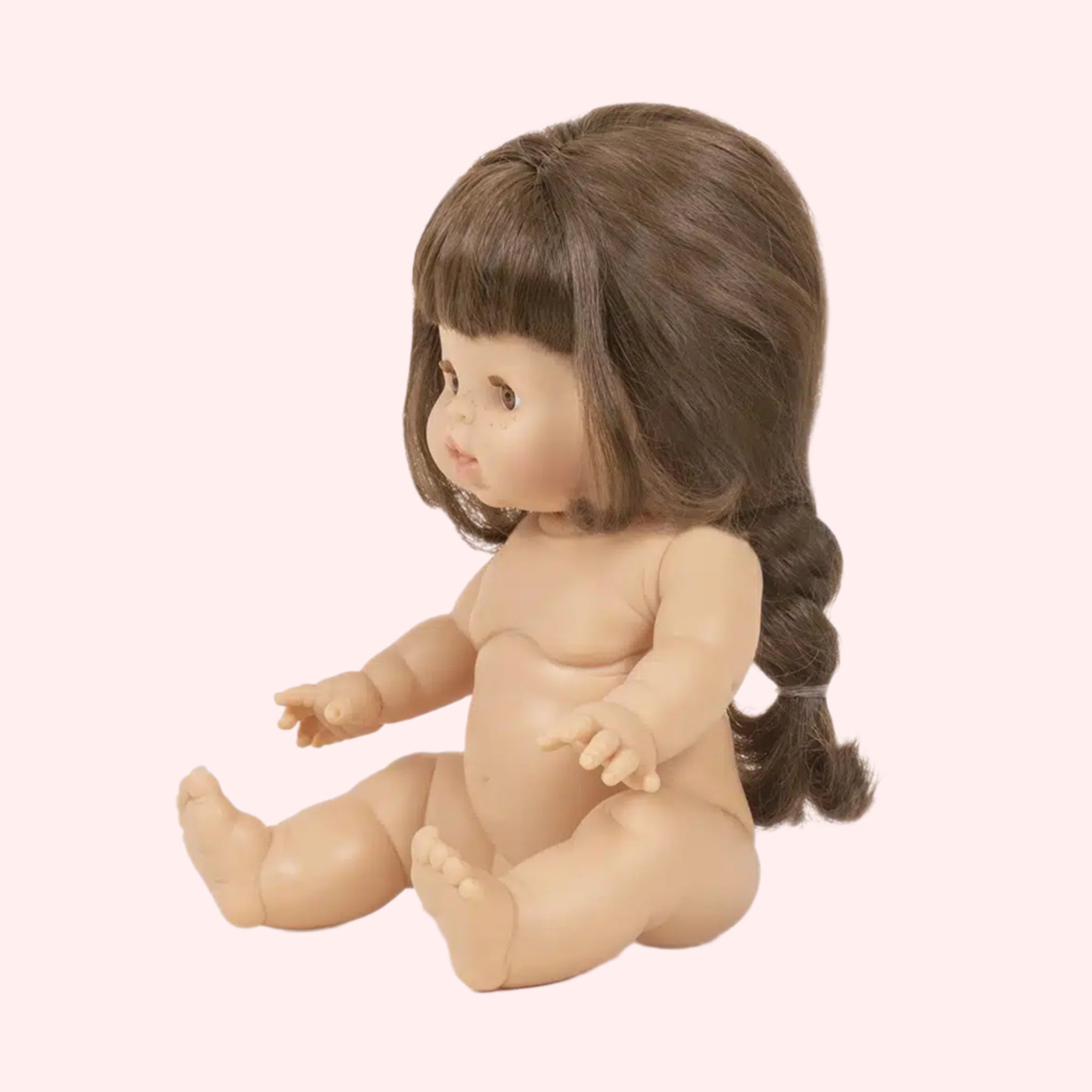 A baby girl doll with a brown braided hairstyle.