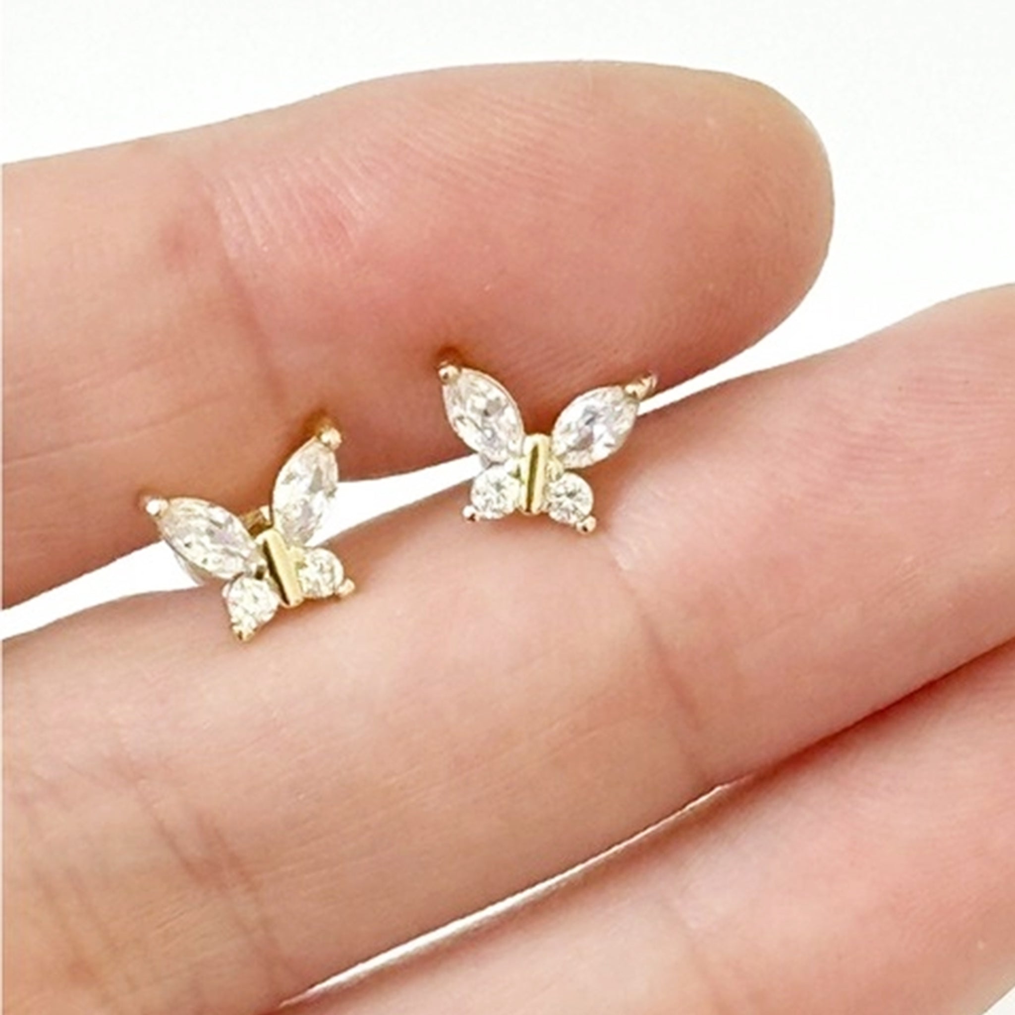 A pair of gold and CZ stone butterfly shaped stud earrings. 