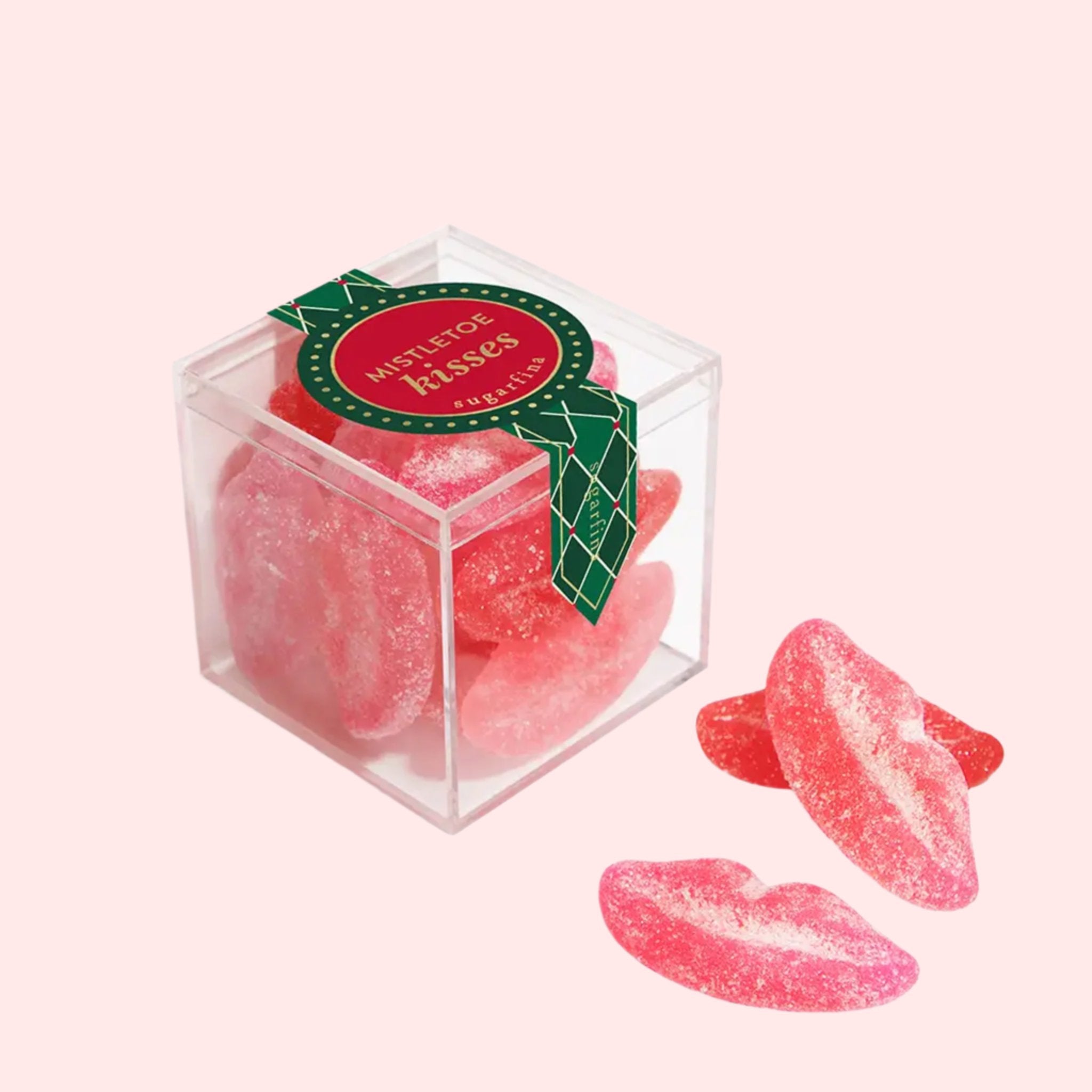 An acrylic box of lip shaped candies with a sour sugar coating. 