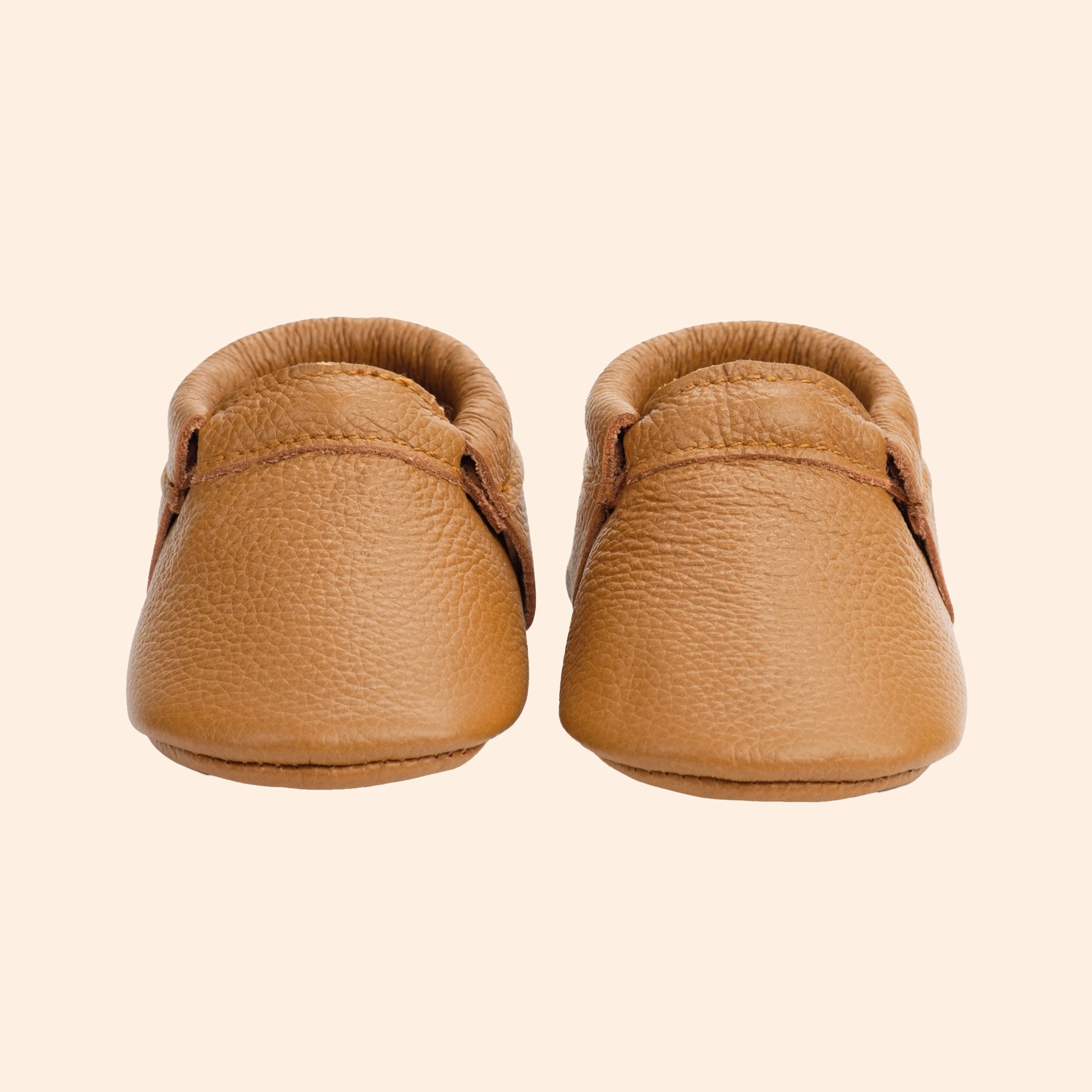 A pair of tan leather moccasins. 