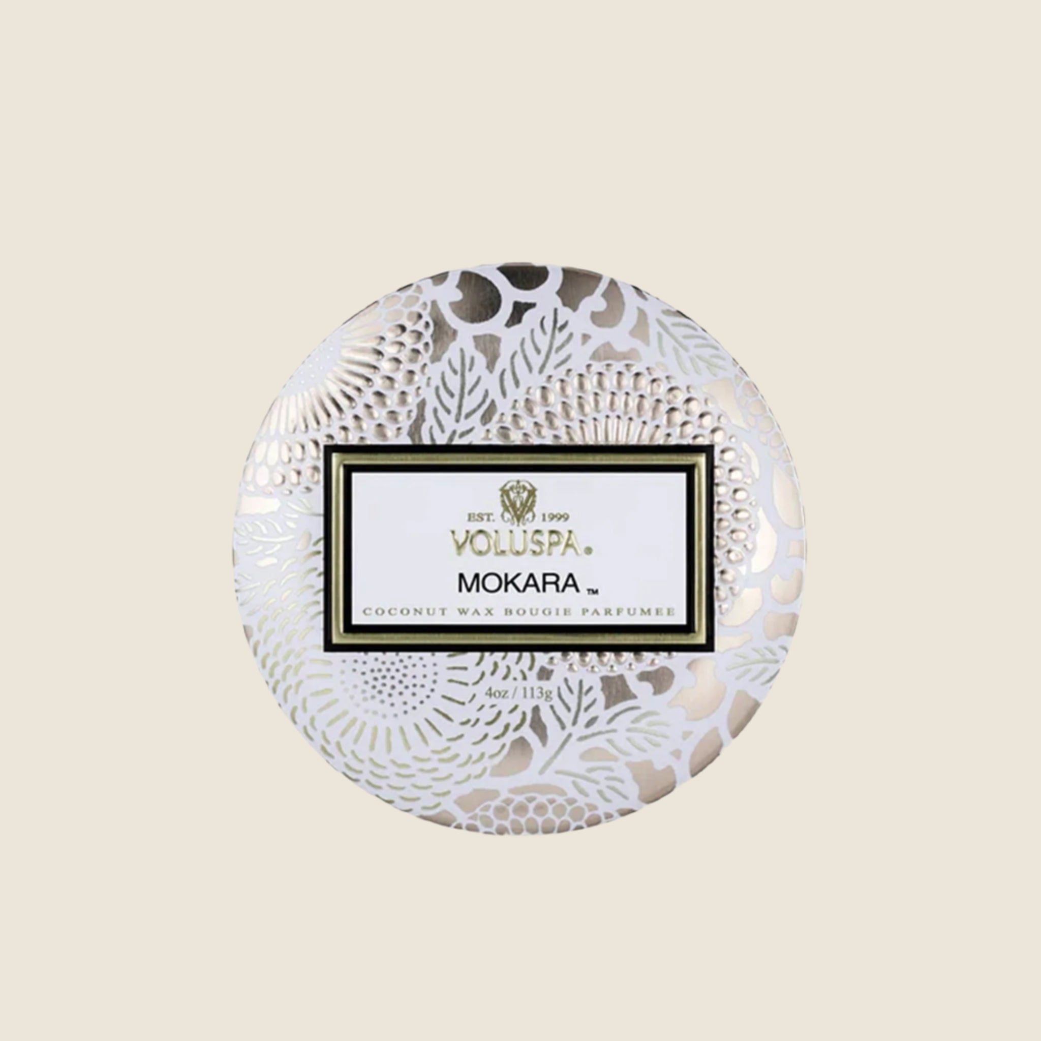 A decorative tin single wick candle with a lid and a label that reads, &quot;Voluspa Mokara&quot;