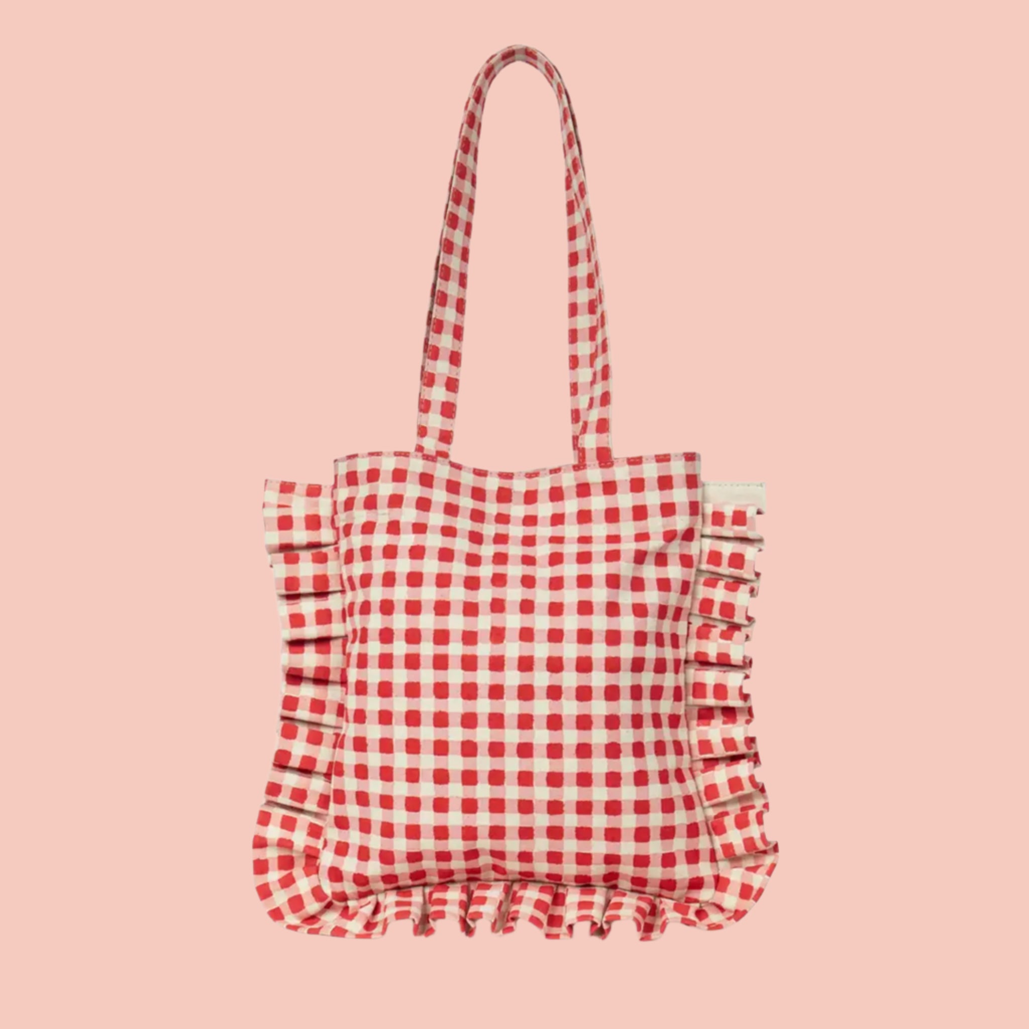 A red and white gingham printed tote bag with shoulder straps and a ruffle edge detail. 