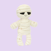 A mummy shaped stuffed toy. 