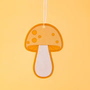 A yellow and orange mushroom shaped air freshener. 