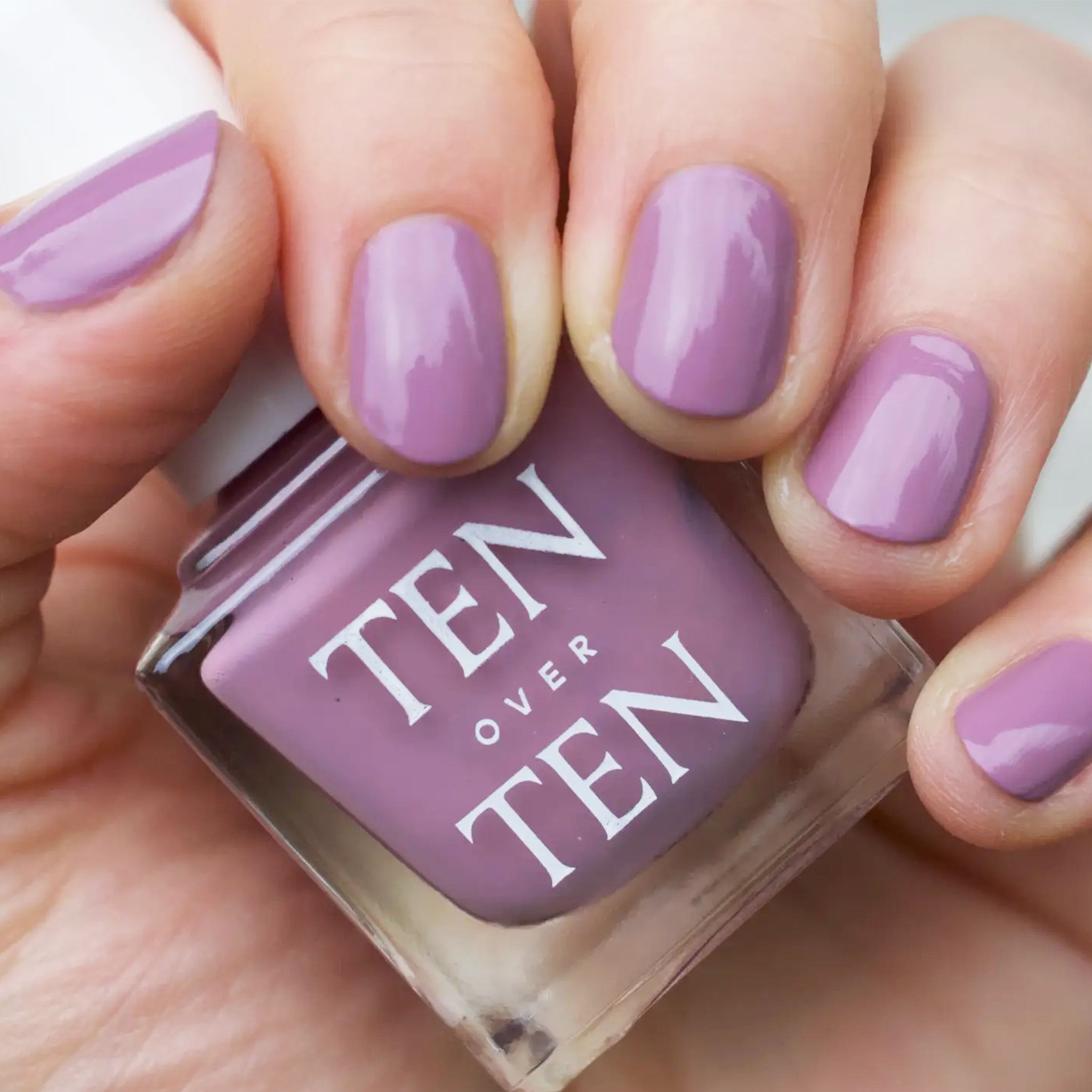 A purple nail polish with a satin/gloss finish. 