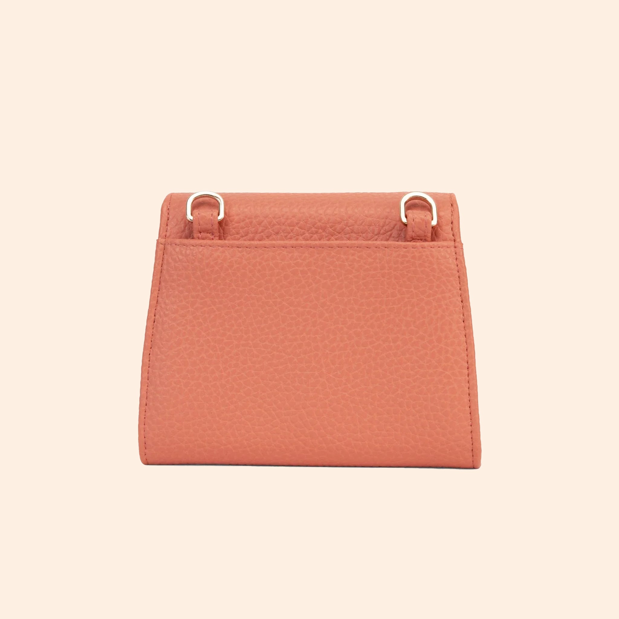 A light pinkish orange vegan leather wallet with a thin removable crossbody strap.