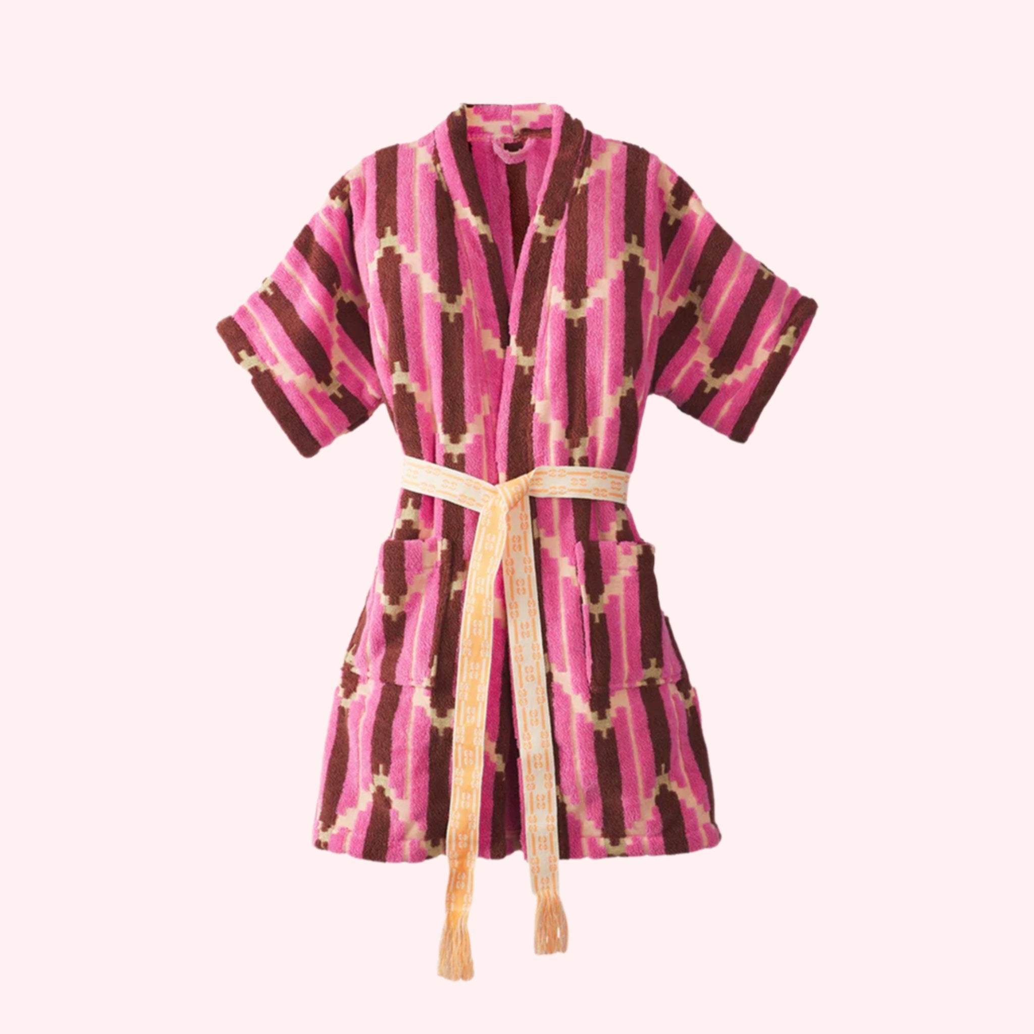 A pink kimono robe with a burnt orange and yellow chevron print. 