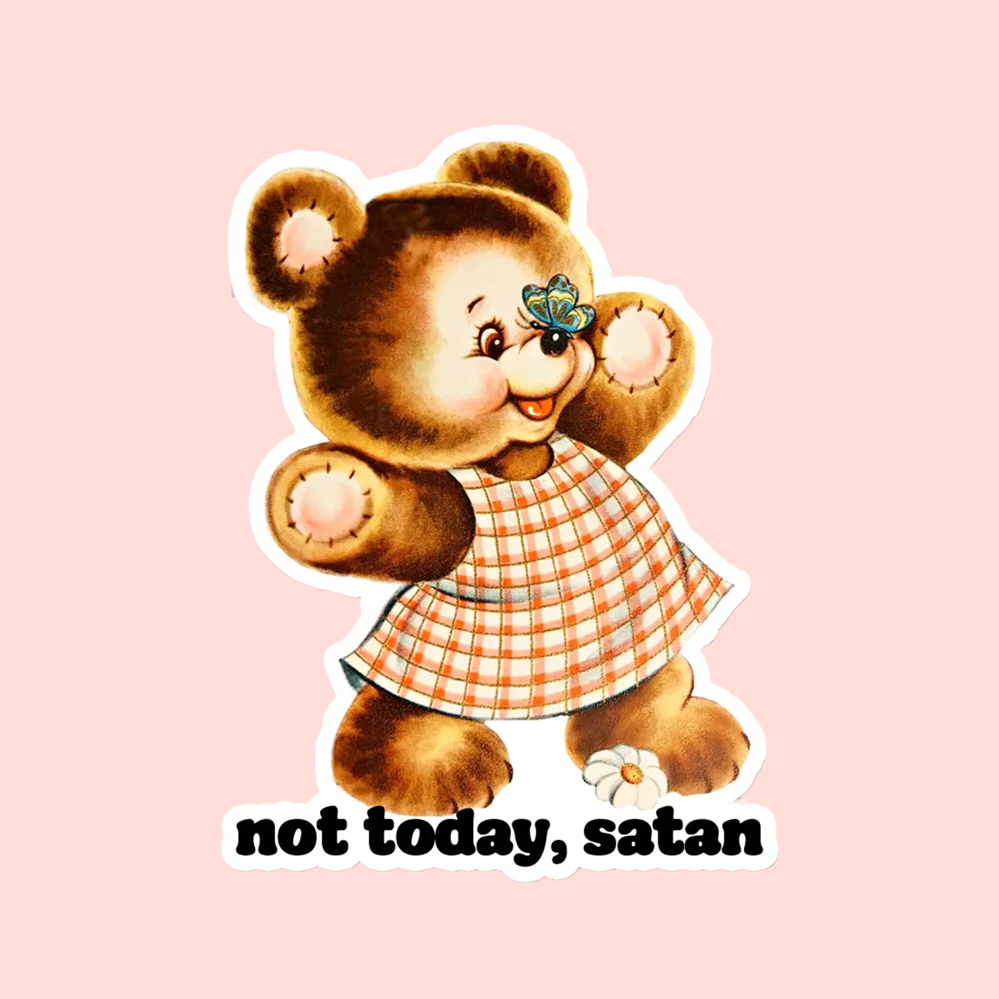 A brown teddy bear shaped sticker wearing a plaid dress and text underneath that reads, 'not today, satan'. 