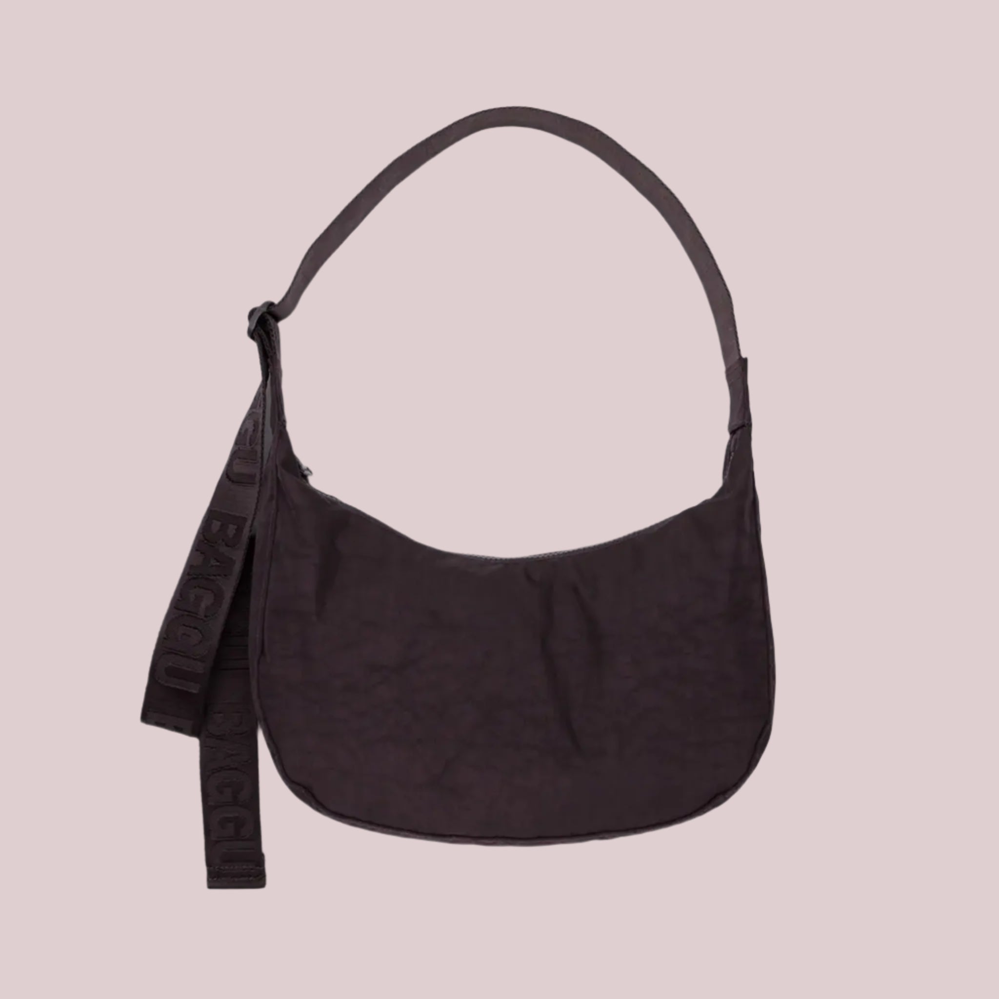 A purple/brownish colored nylon crescent bag with a black strap and details. 