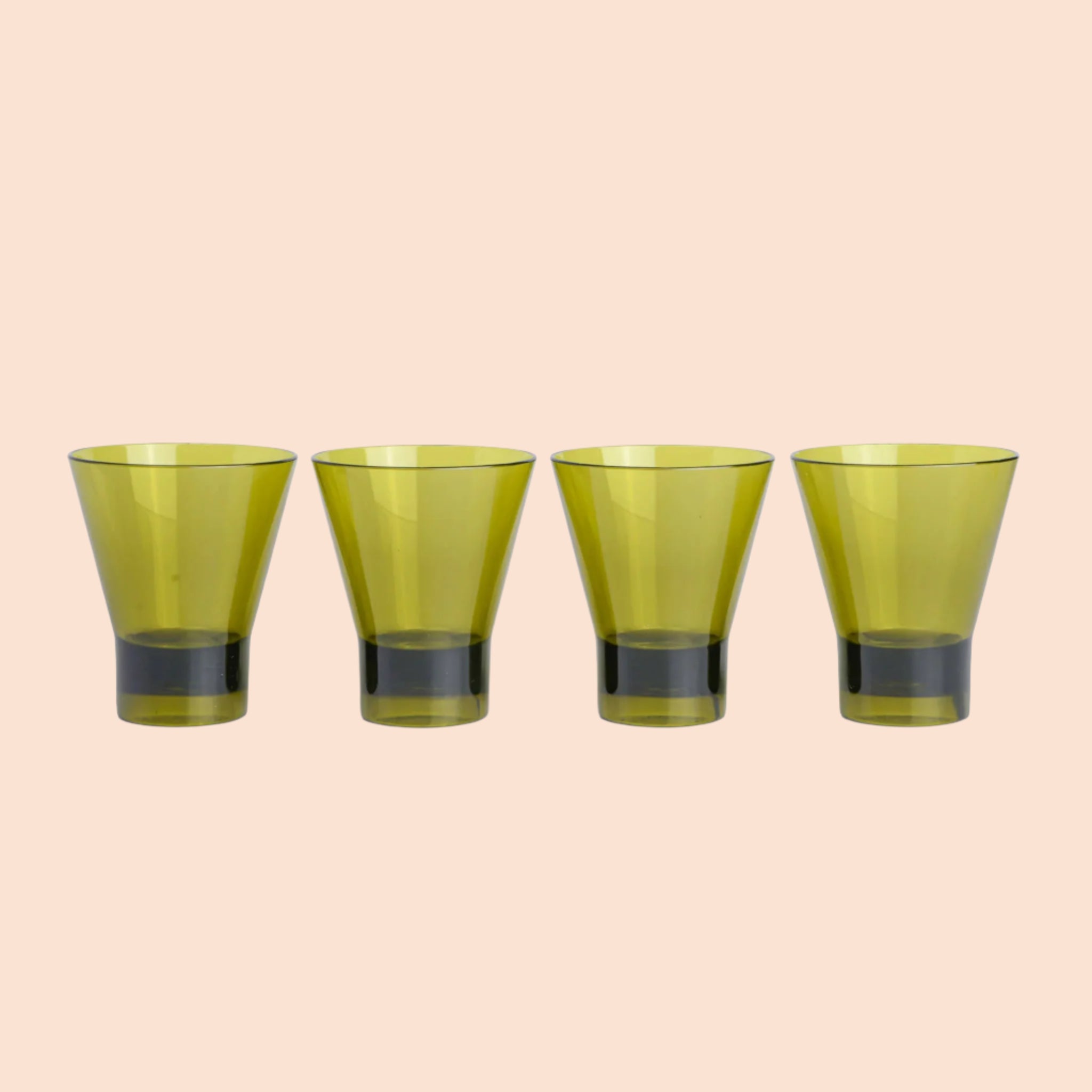 A set of four glass, olive green tumblers in a pink and orange striped box.