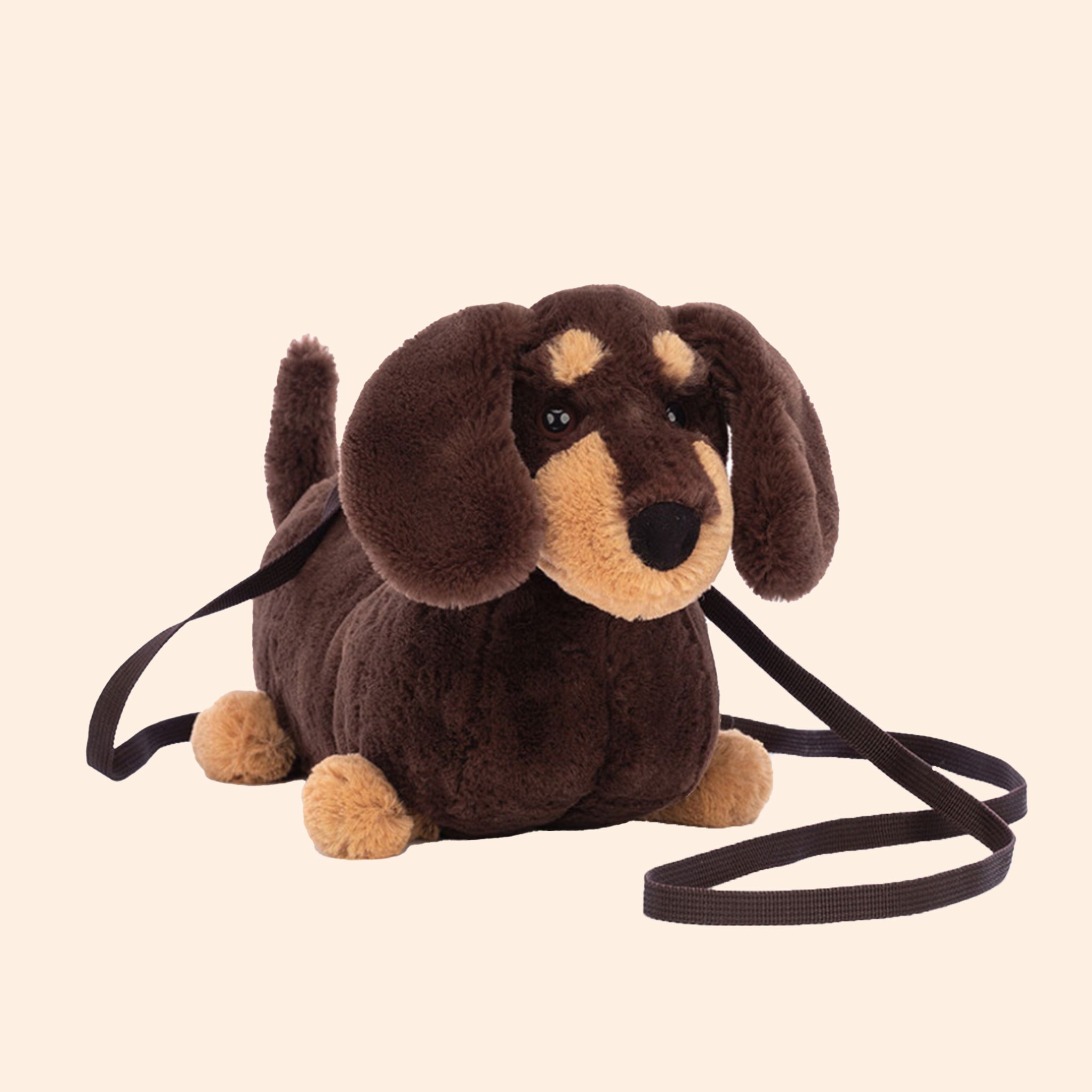 A brown and tan wiener dog stuffed toy bag with a zipper closure and a crossbody strap. 