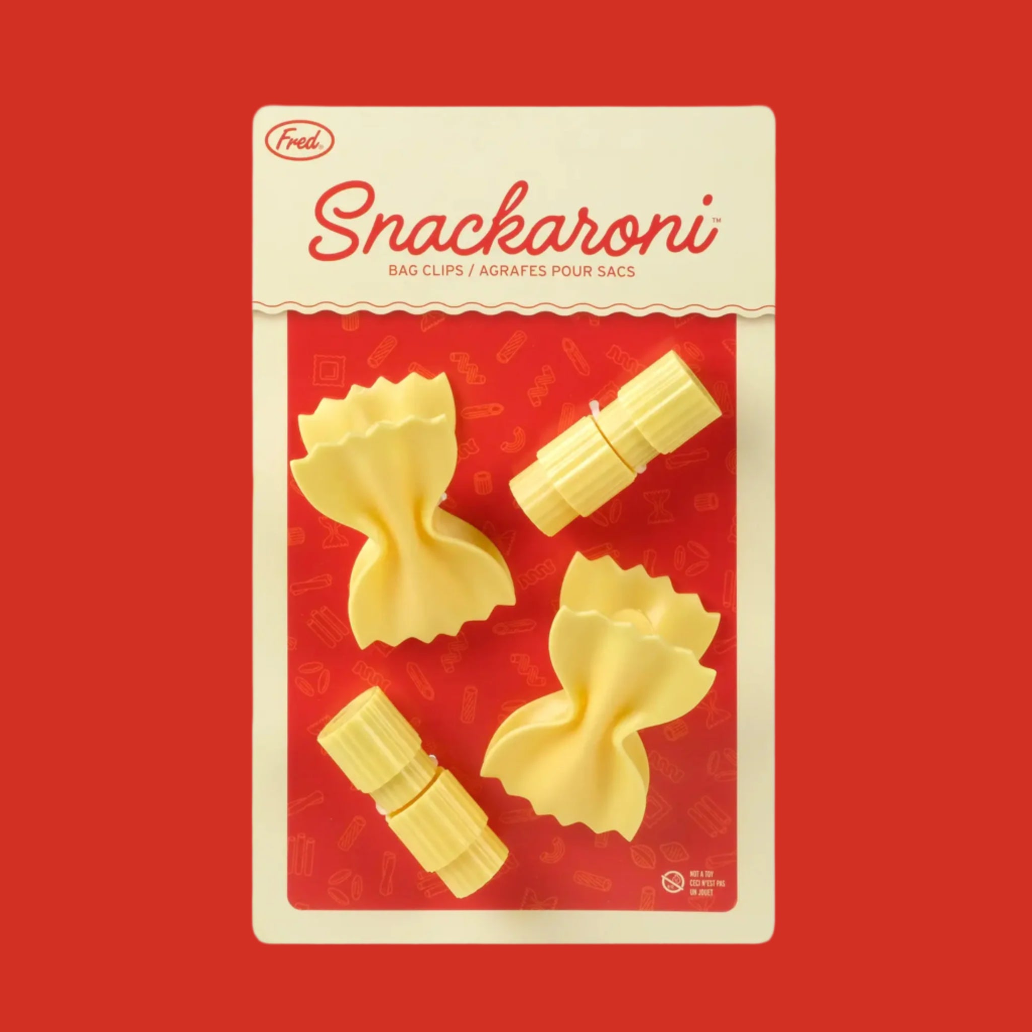 A pack of four pasta shaped bag clips with text at the top that reads, &#39;Snackaroni Bag Clips&#39;. 