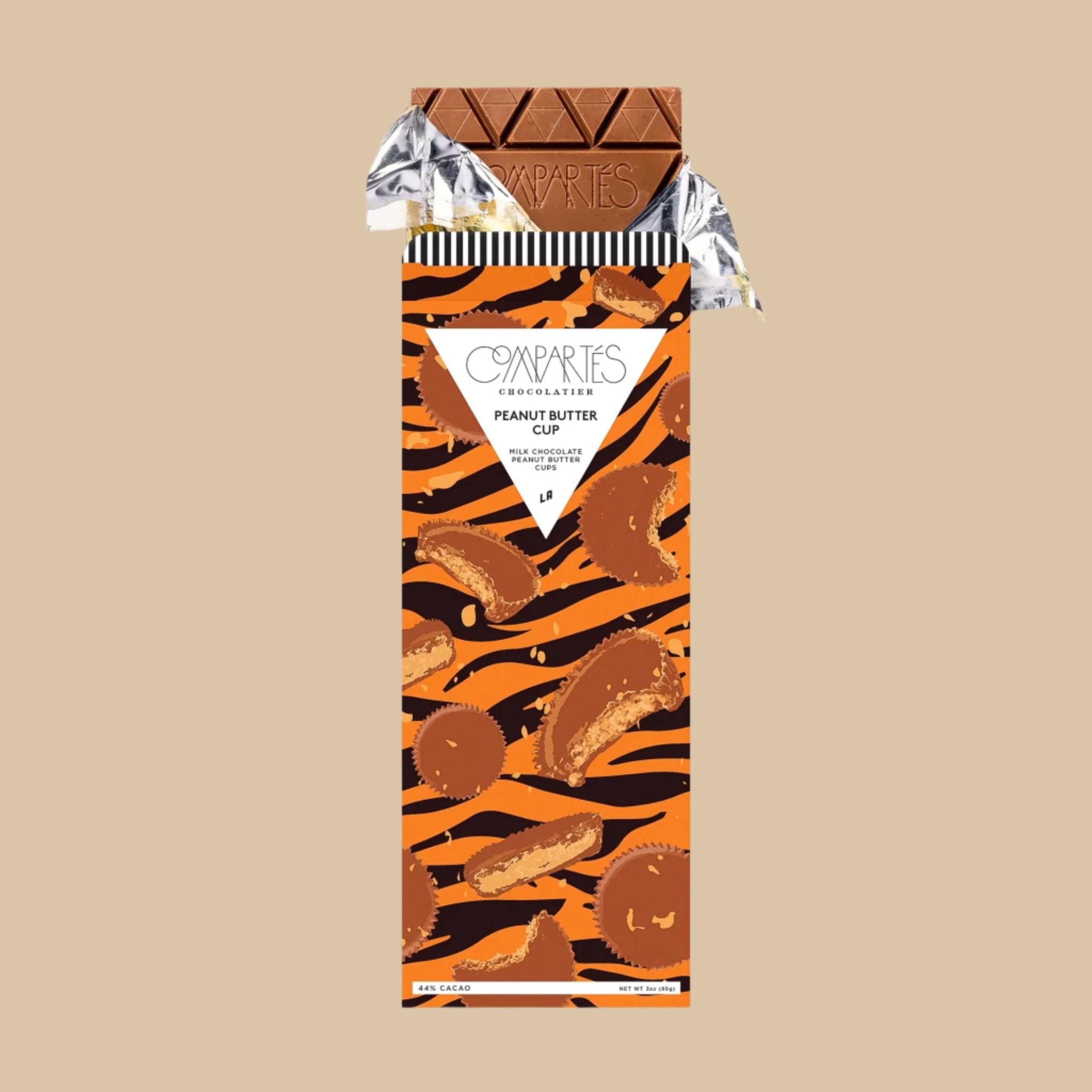 A chocolate bar with orange and black tiger print packaging with graphics of peanut butter cups and text that reads, 'Compartes Chocolatier Peanut Butter Cup'. 