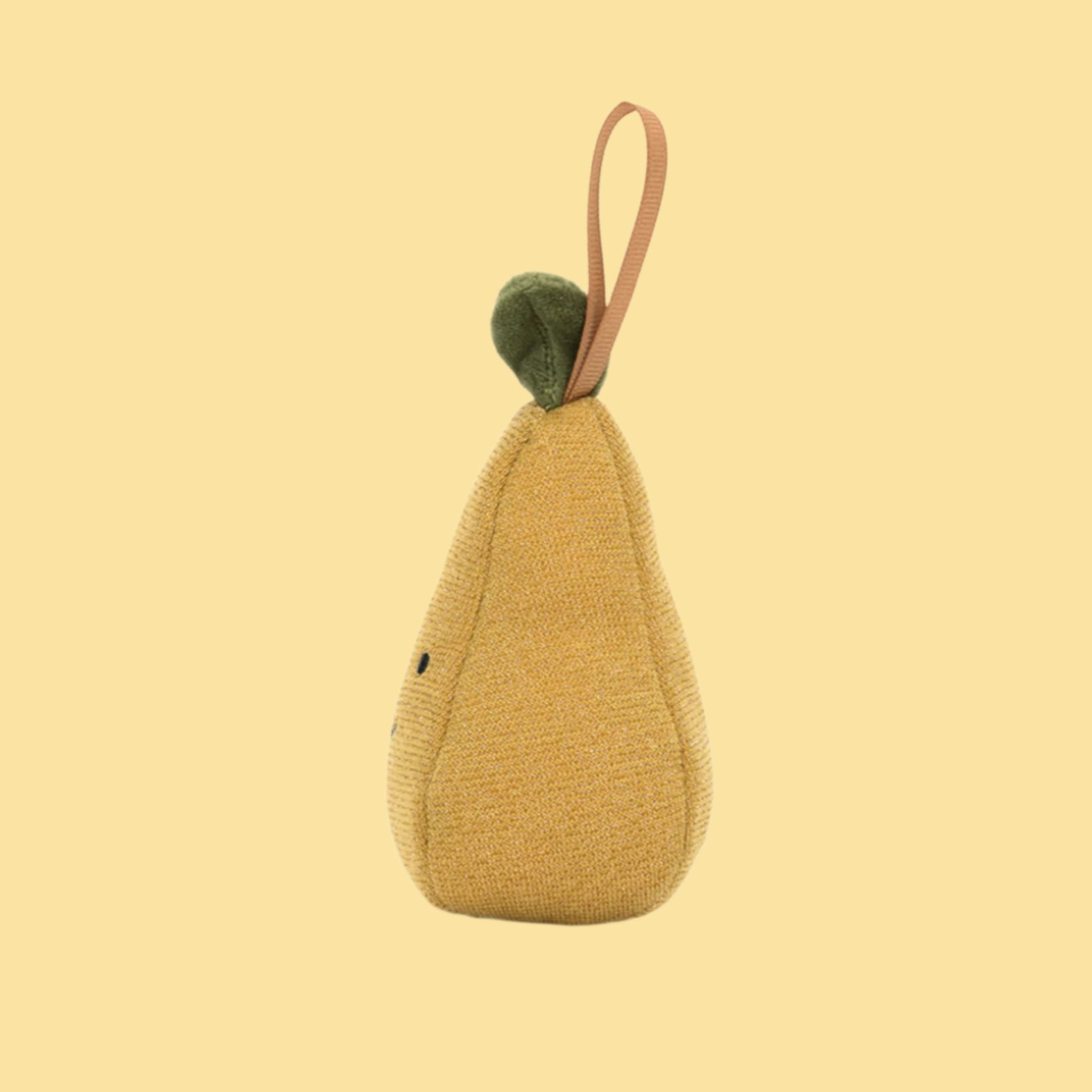 A green pear shaped stuffed toy ornament with a smiling face and loop for hanging. 