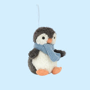 A mini stuffed animal penguin shaped ornament. 