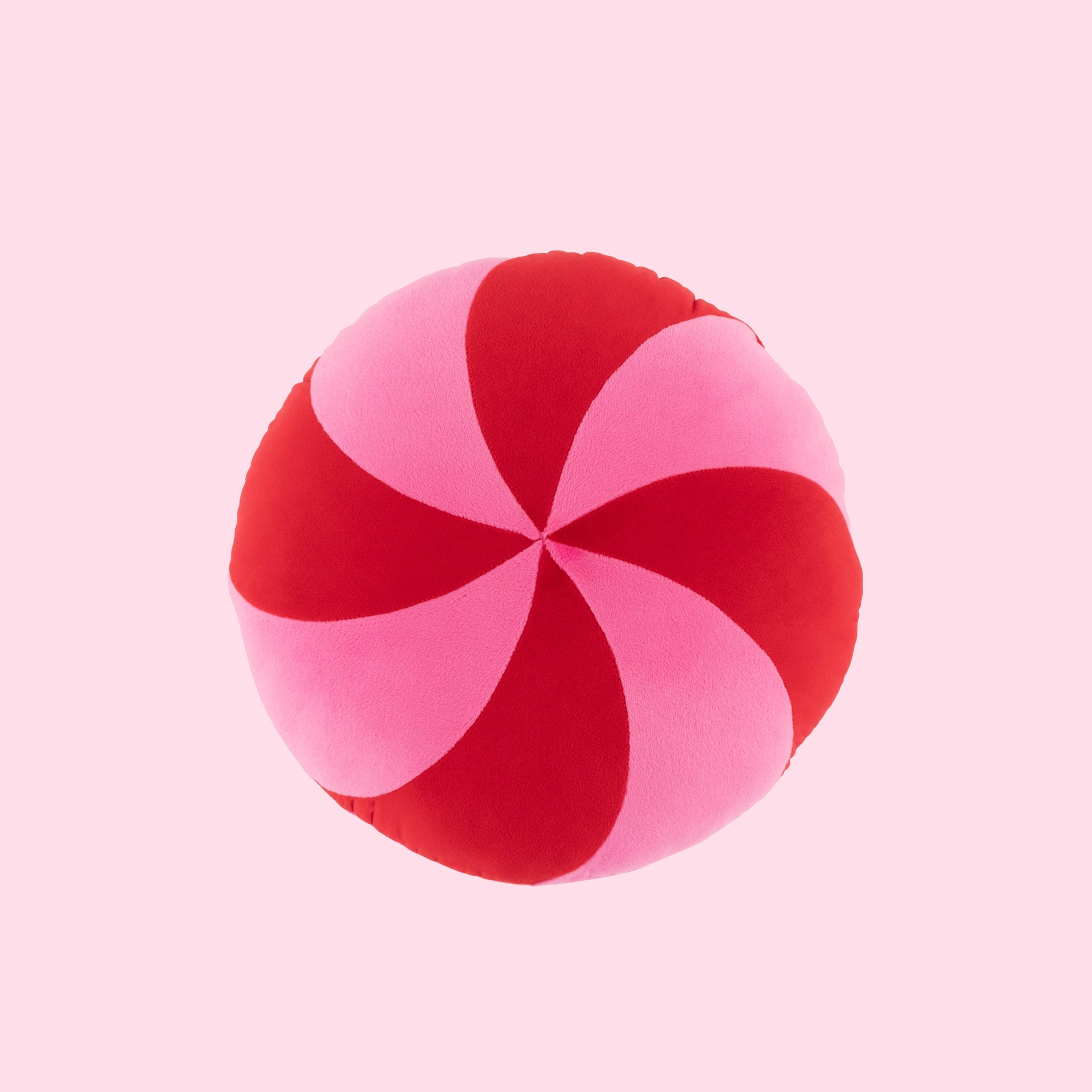 A red and pink peppermint candy shaped pillow. 