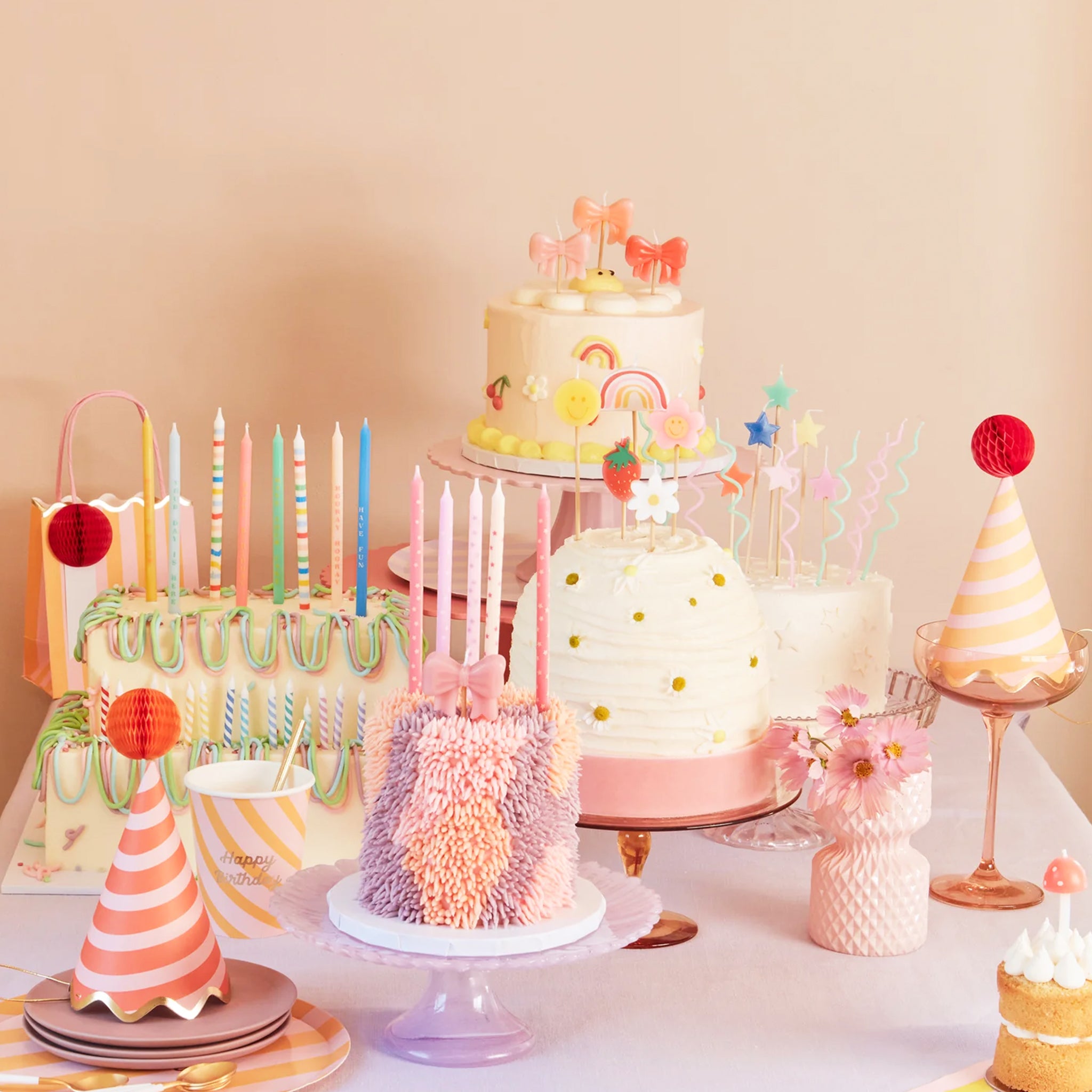 A set of four bow shaped birthday candles.