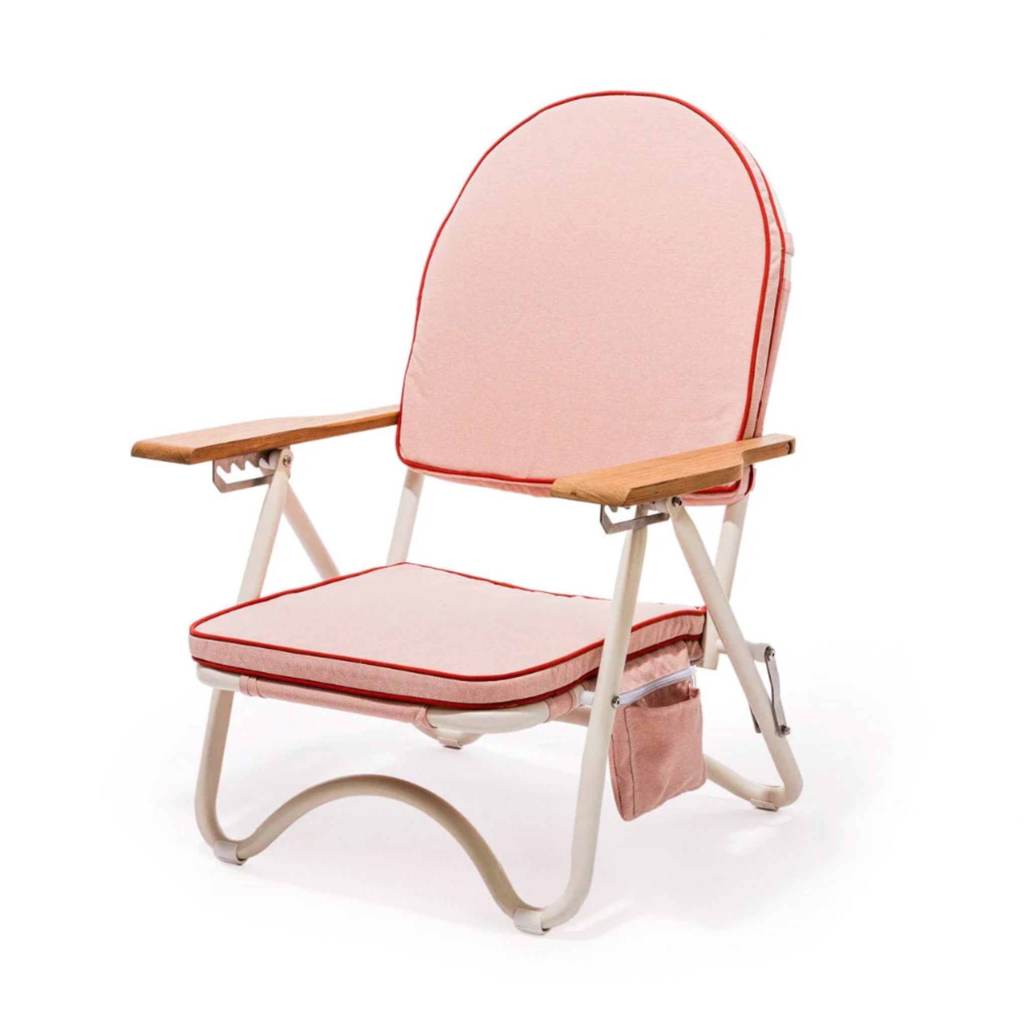 A pink arched folding beach chair with a reddish/dark pink lining around the edge and wood arm rests.