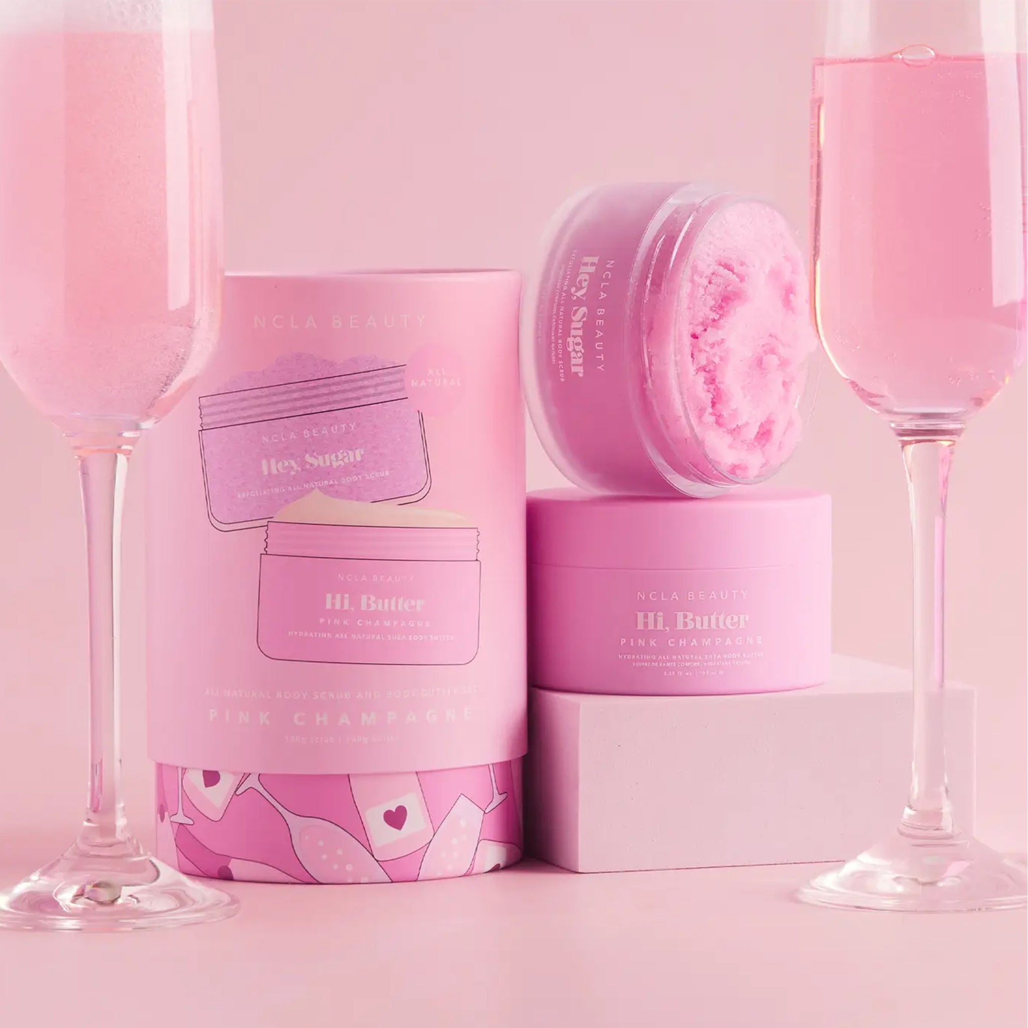 A set of a body butter and a body scrub with a pink champagne scent. 