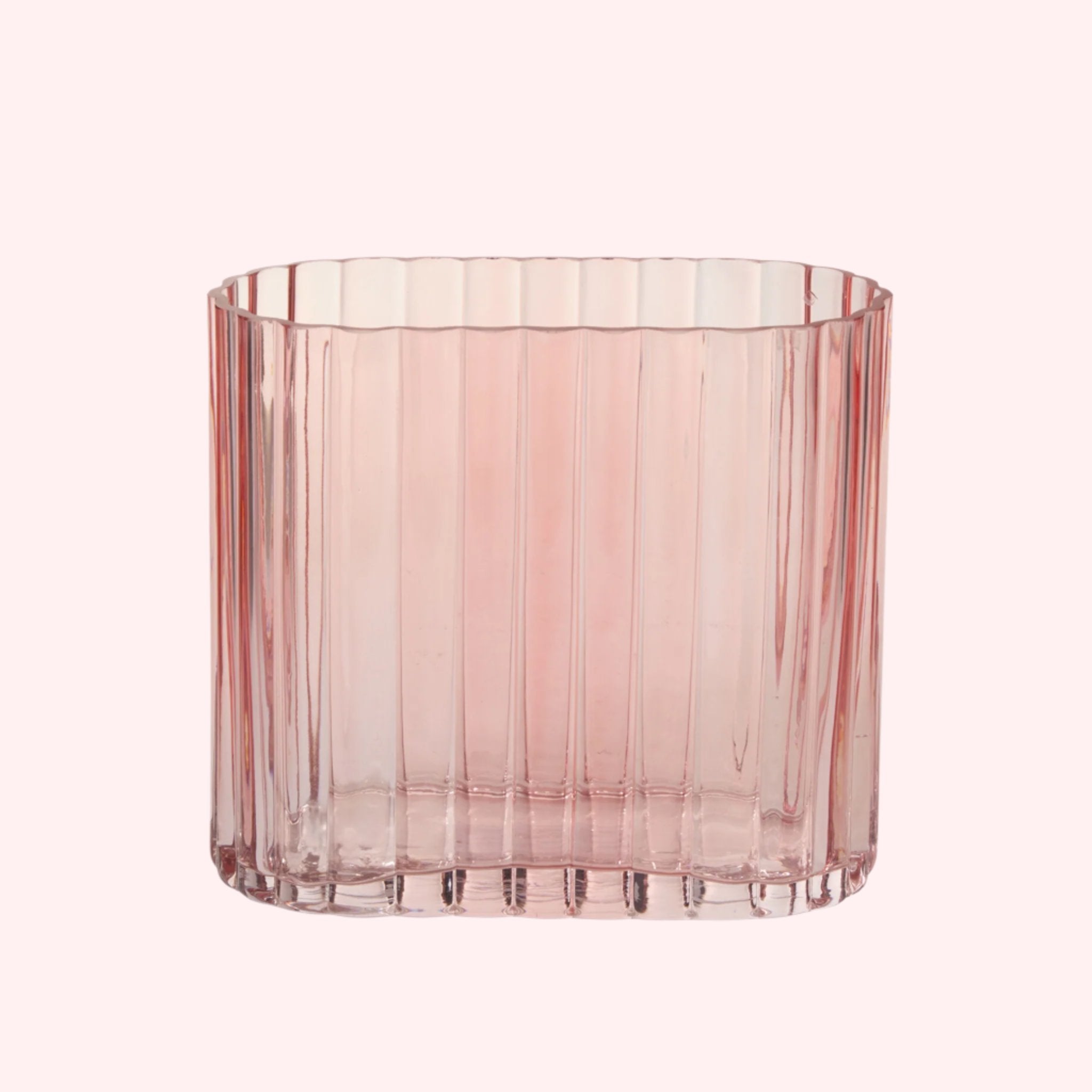 A light pink ribbed vase. Florals not included with purchase. 