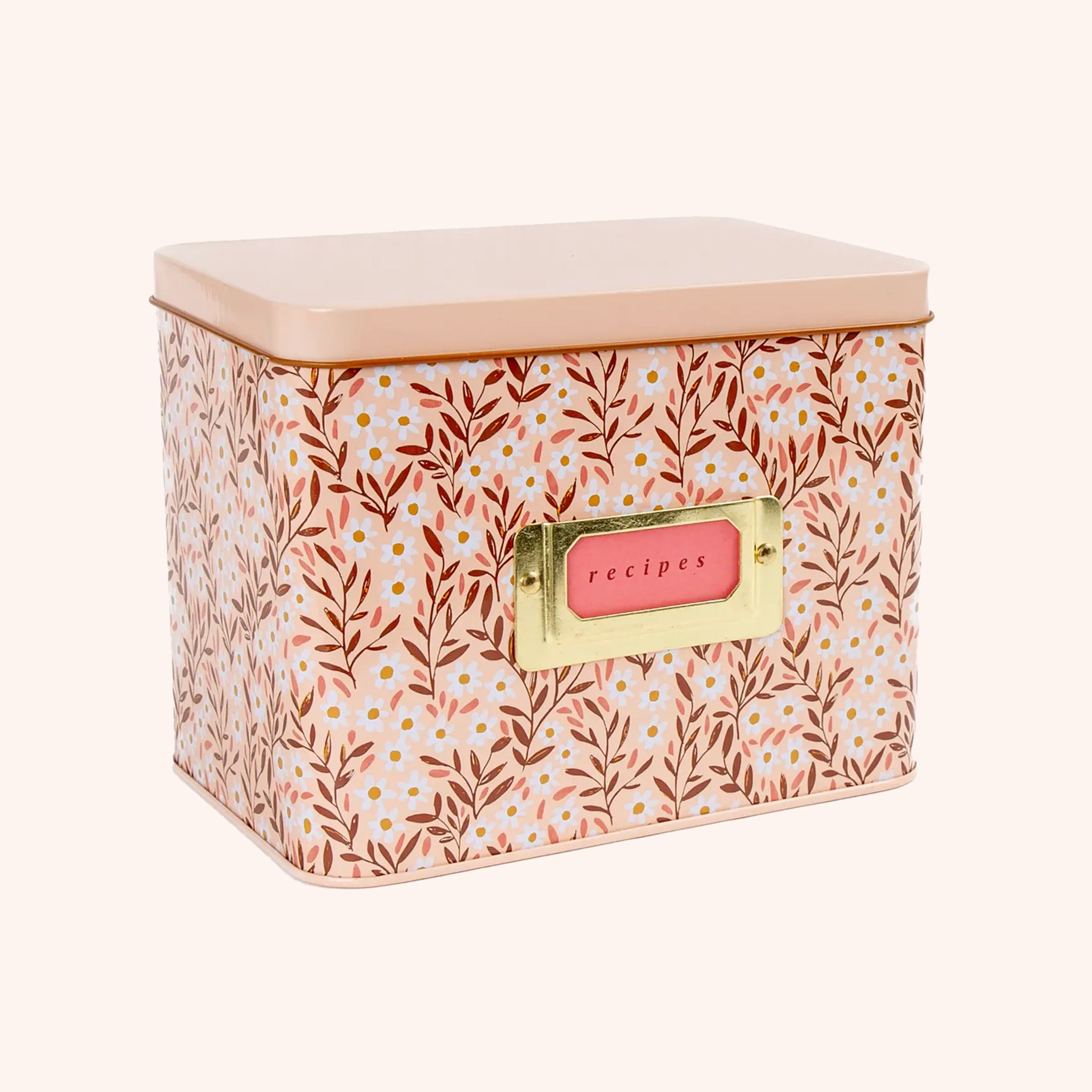 A metal recipe box with a pink daisy pattern with recipe cards and dividers.