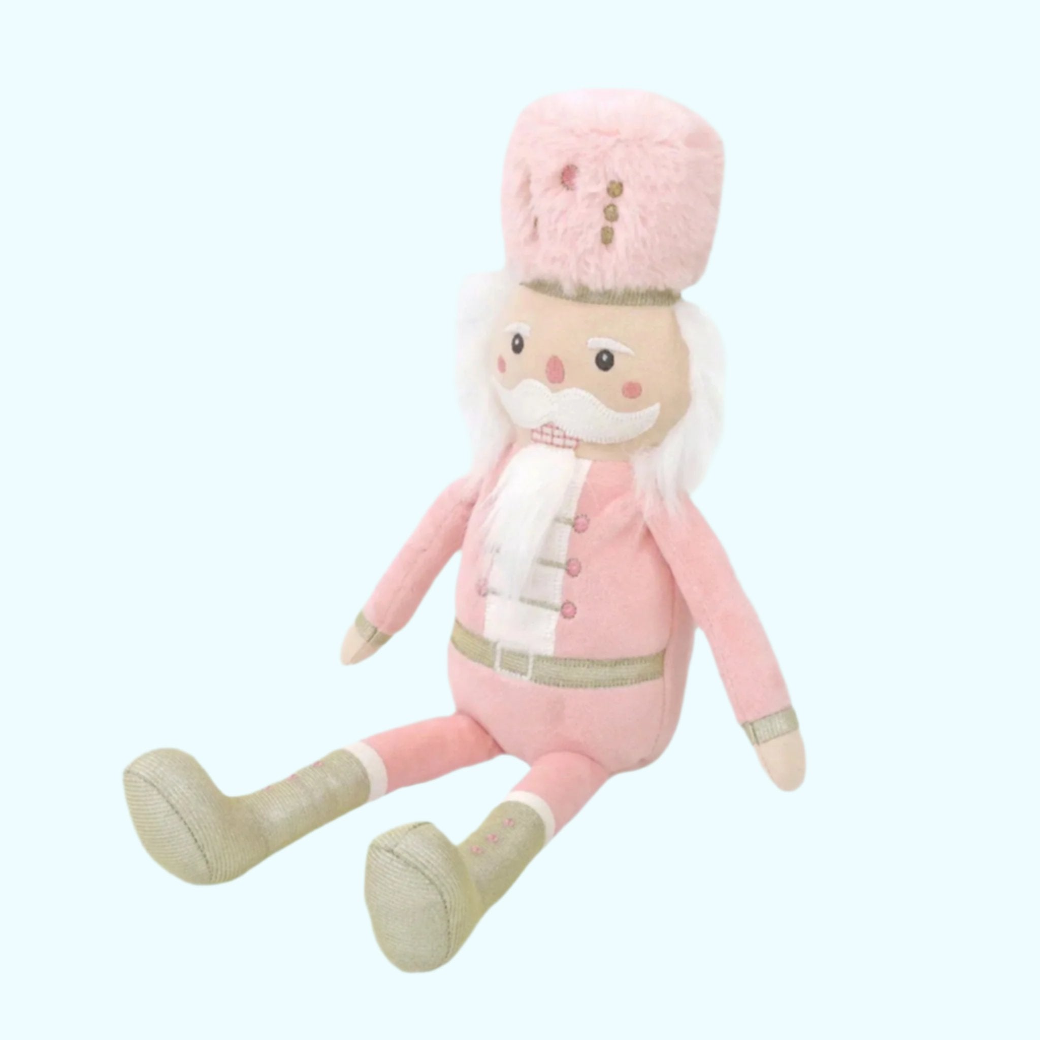 A pink and gold nutcracker stuffed toy.