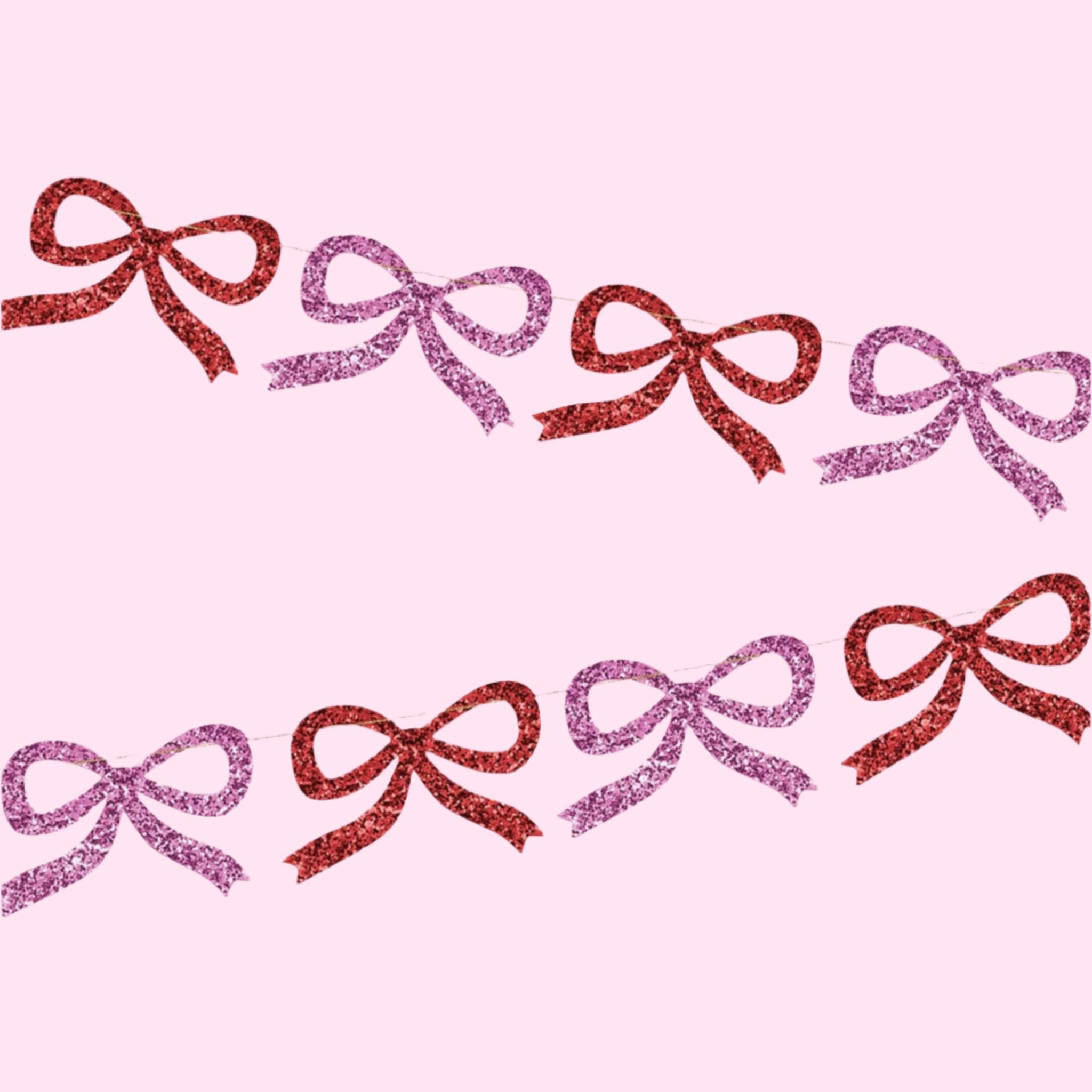 A pink and red glitter bow garland made out of paper cut outs. 