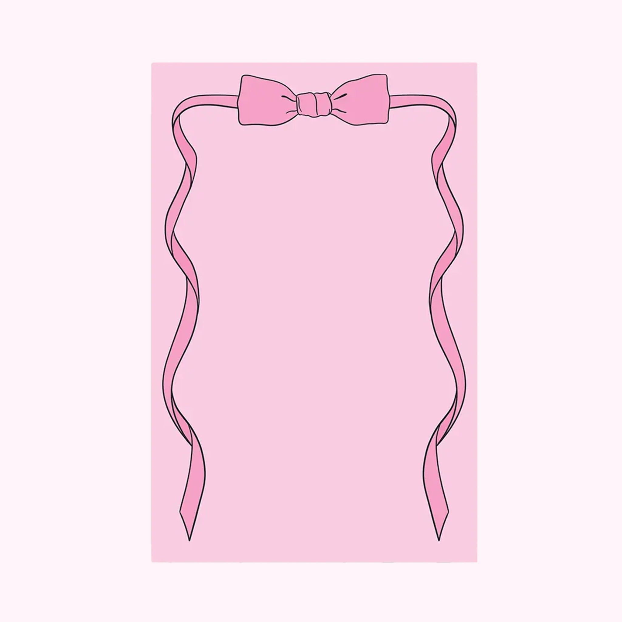 A pink notepad with bow shaped graphic on the top.