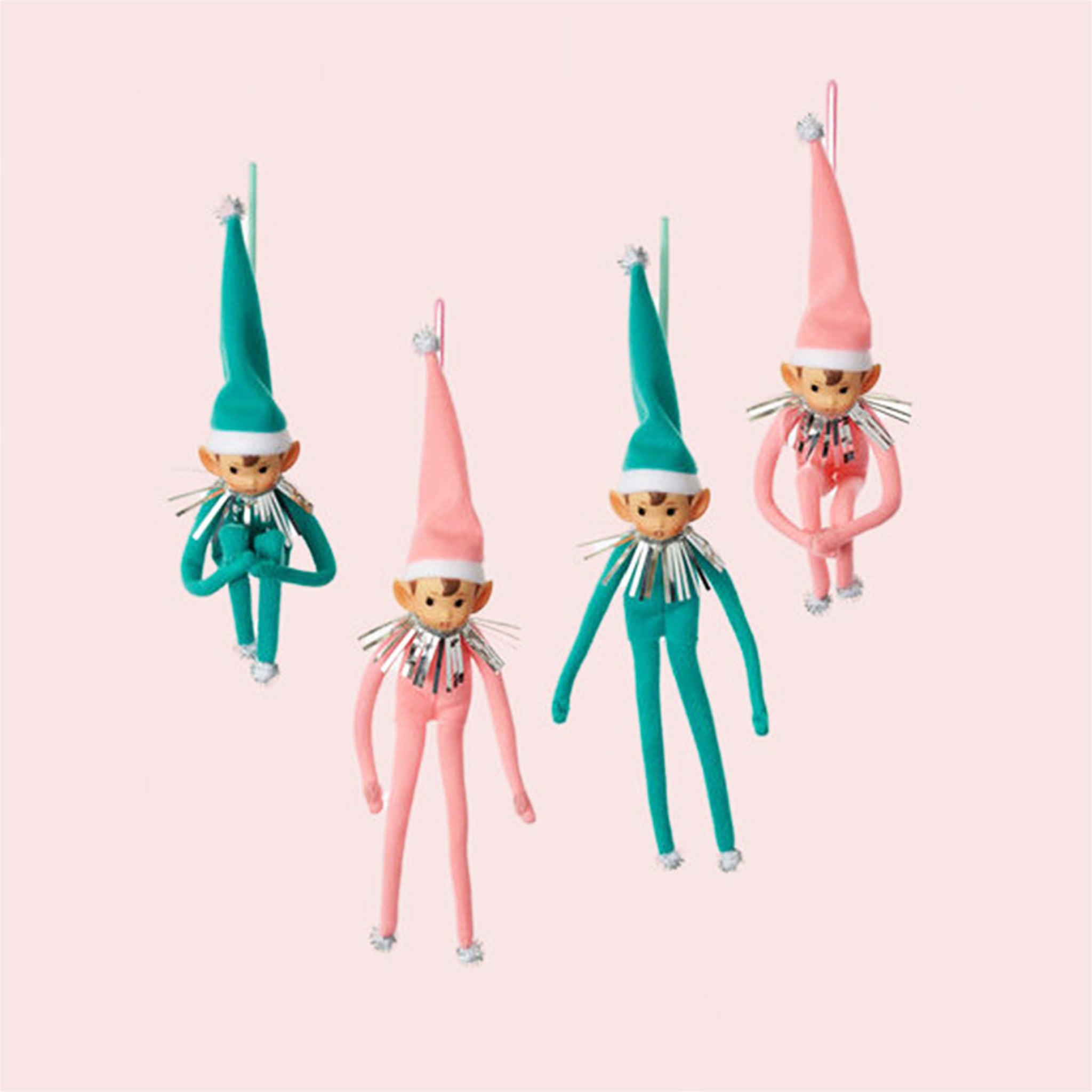 A photo of pink and teal elf shaped ornament.
