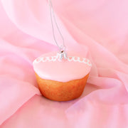 A pink cupcake shaped glass ornament. 