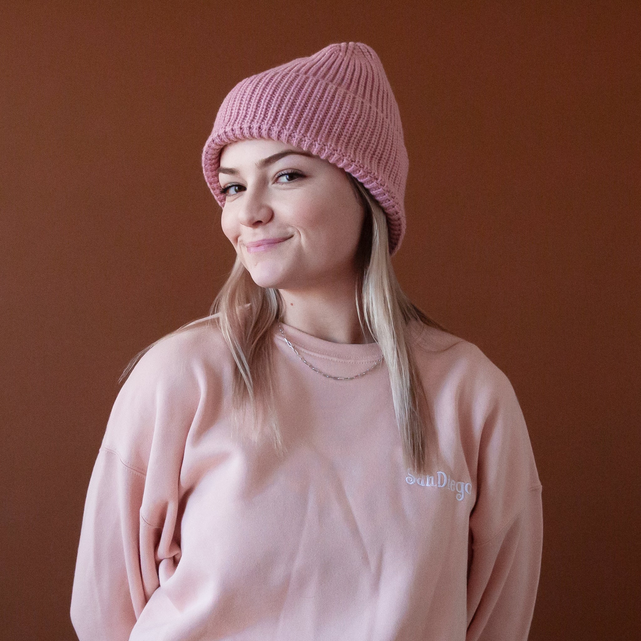 A dusty rose knit beanie. 