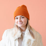 An orange knit beanie. 