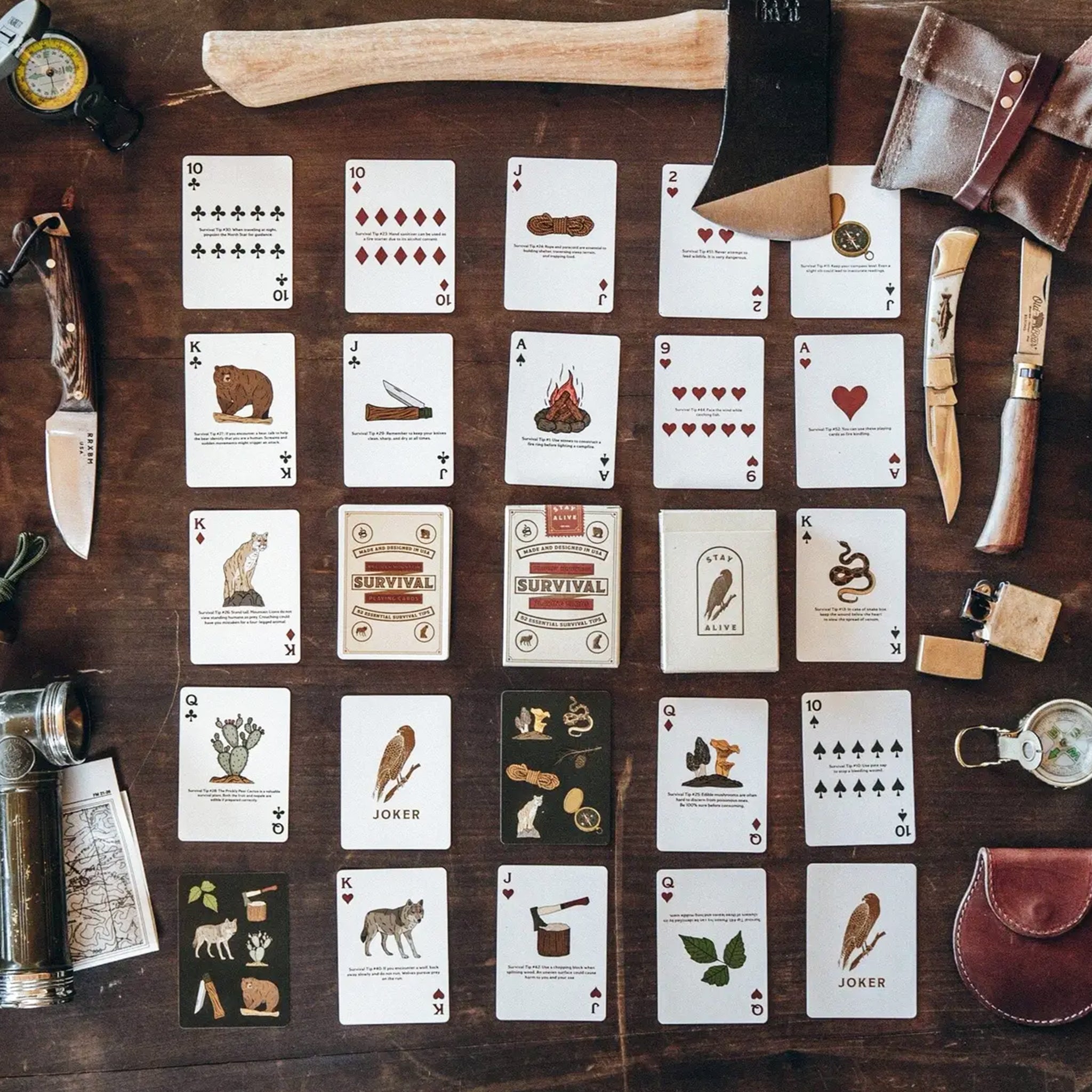 A deck of playing cards in a green box with a survival tip on each card. The box reads, 'Made and Designed in the USA Bradley Mountain Survival Playing Cards 52 Essential Survival Tips'. 