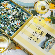 A puzzle with yellow stripes on the box and text that reads, 'Poolside Gossip' and a Gray Malin photo. 