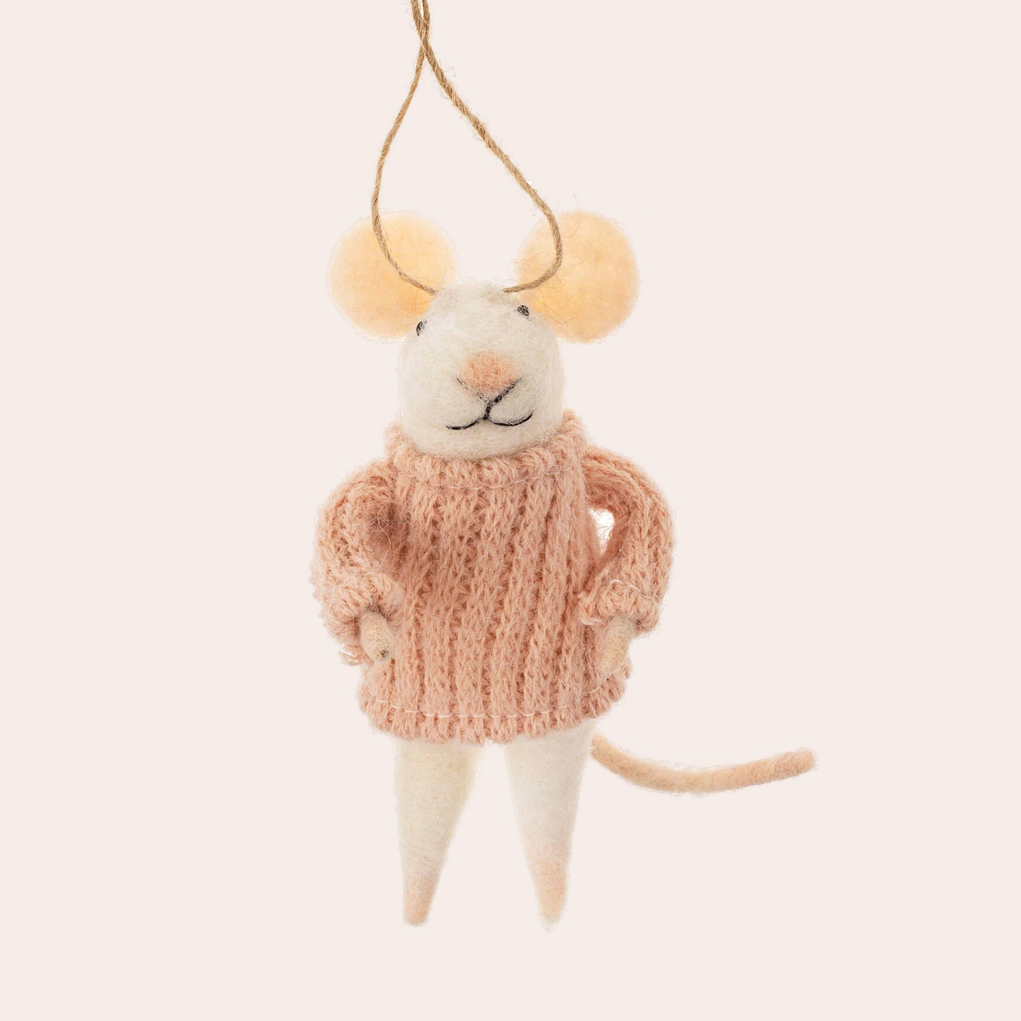 A mouse shaped ornament in a pink sweater. 