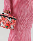 A pink and red Hellot Kitty patterned lunch box with a black handle and zipper.