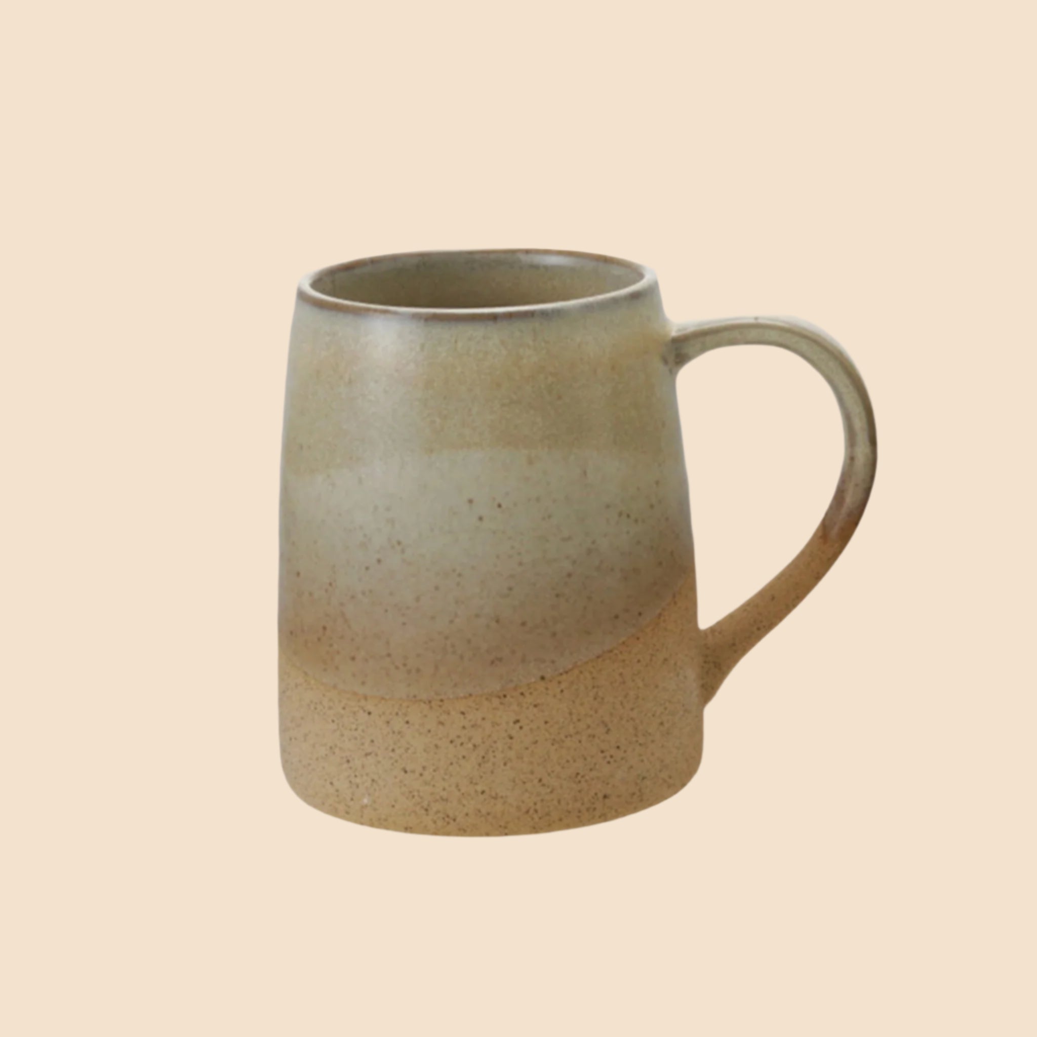 A ceramic mug with a reactive glaze beige finish. 