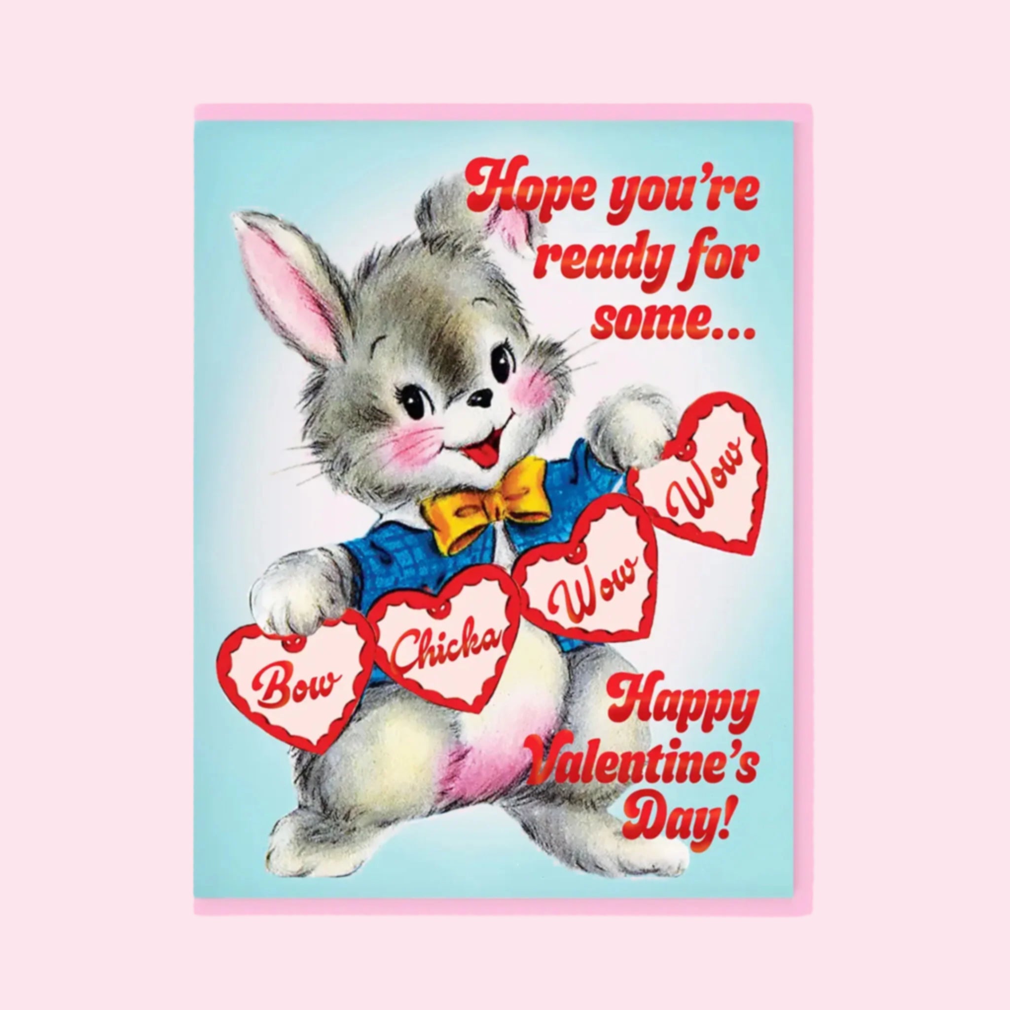 A blue and pink card with an illustration of a bunny holding heart cutouts with text that reads, &#39;Hope you&#39;re ready for some... Bow Chicka Wow Wow Happy Valentine&#39;s Day&#39;. 