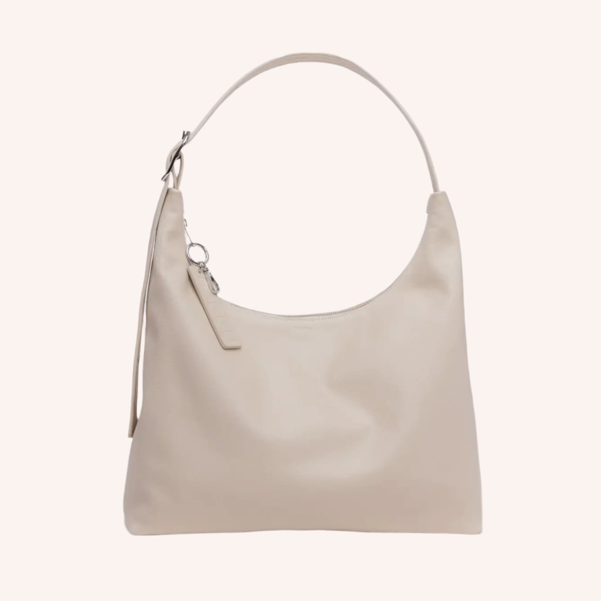 A cream colored leather handbag with a straight bottom and curved body. 