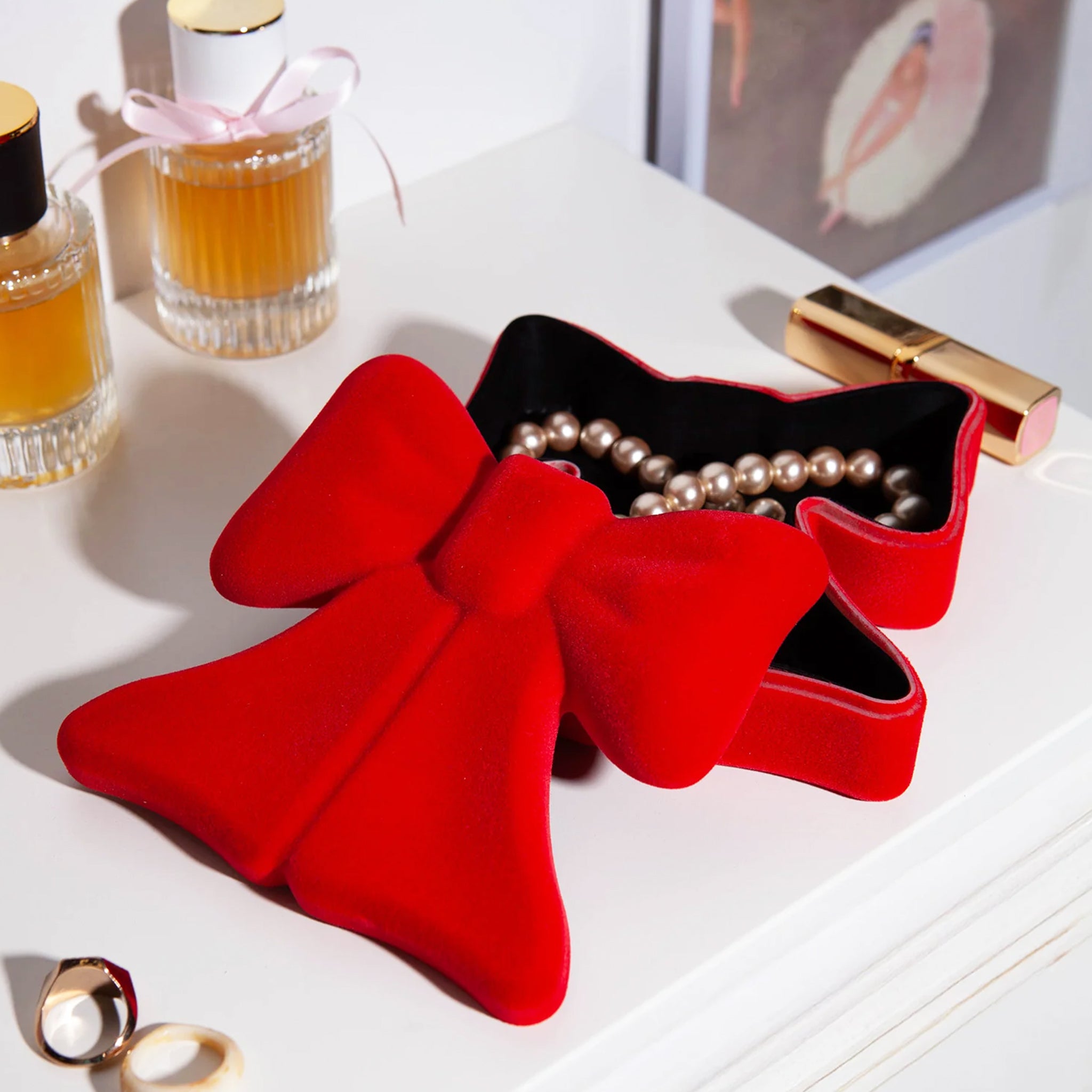 A red velvet bow shaped storage box. 