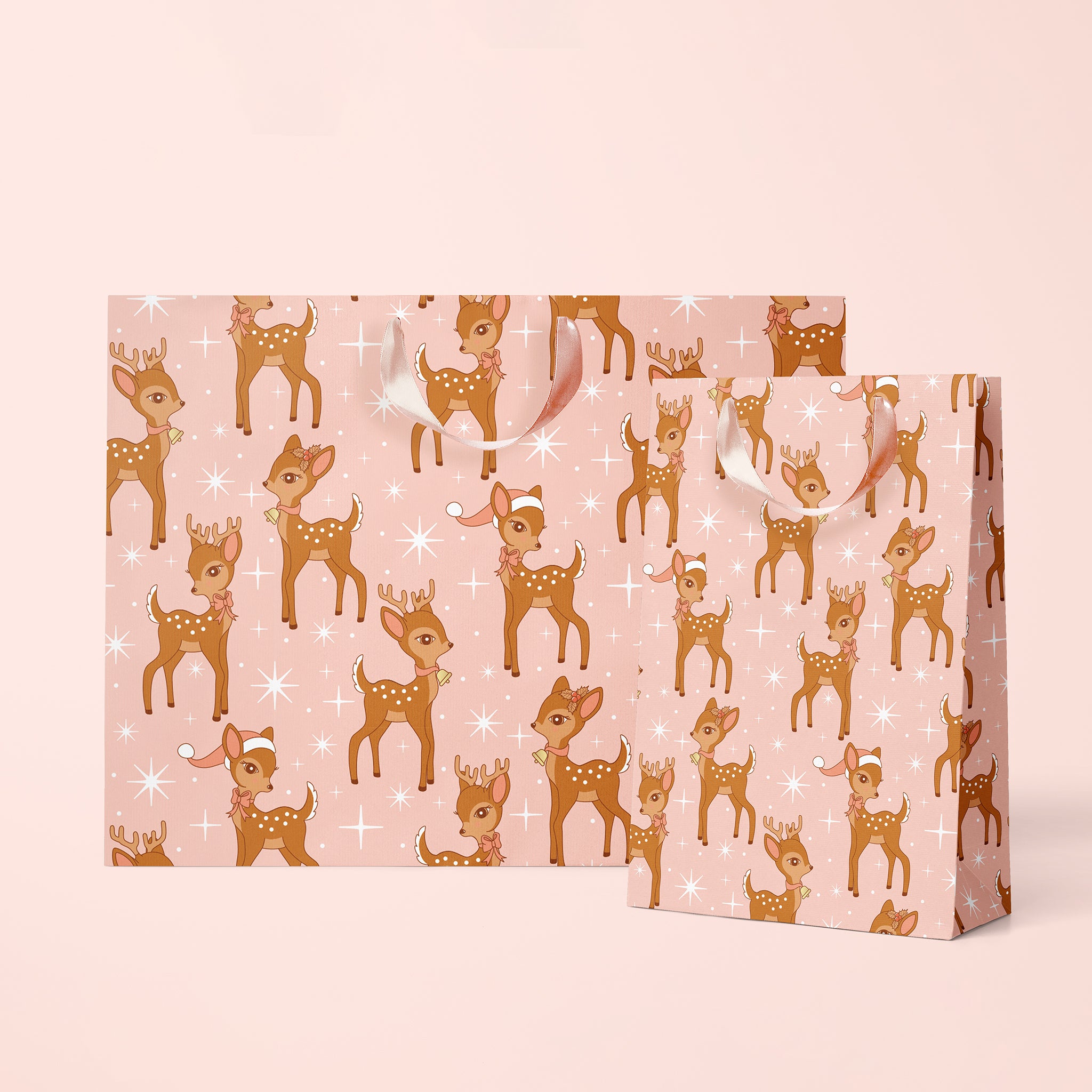 On a pink background is a pink and brown retro deer print gift bag with ribbon handles. 