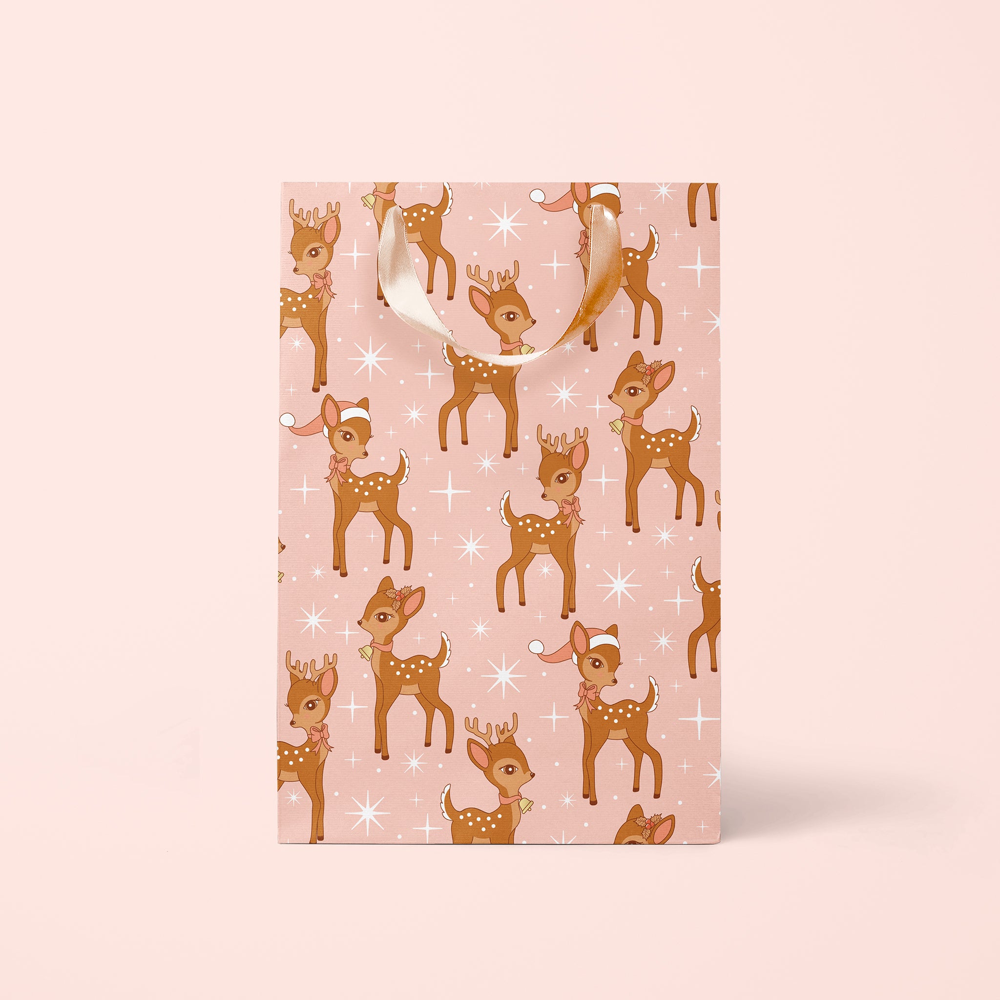 On a pink background is a pink and brown retro deer print gift bag.