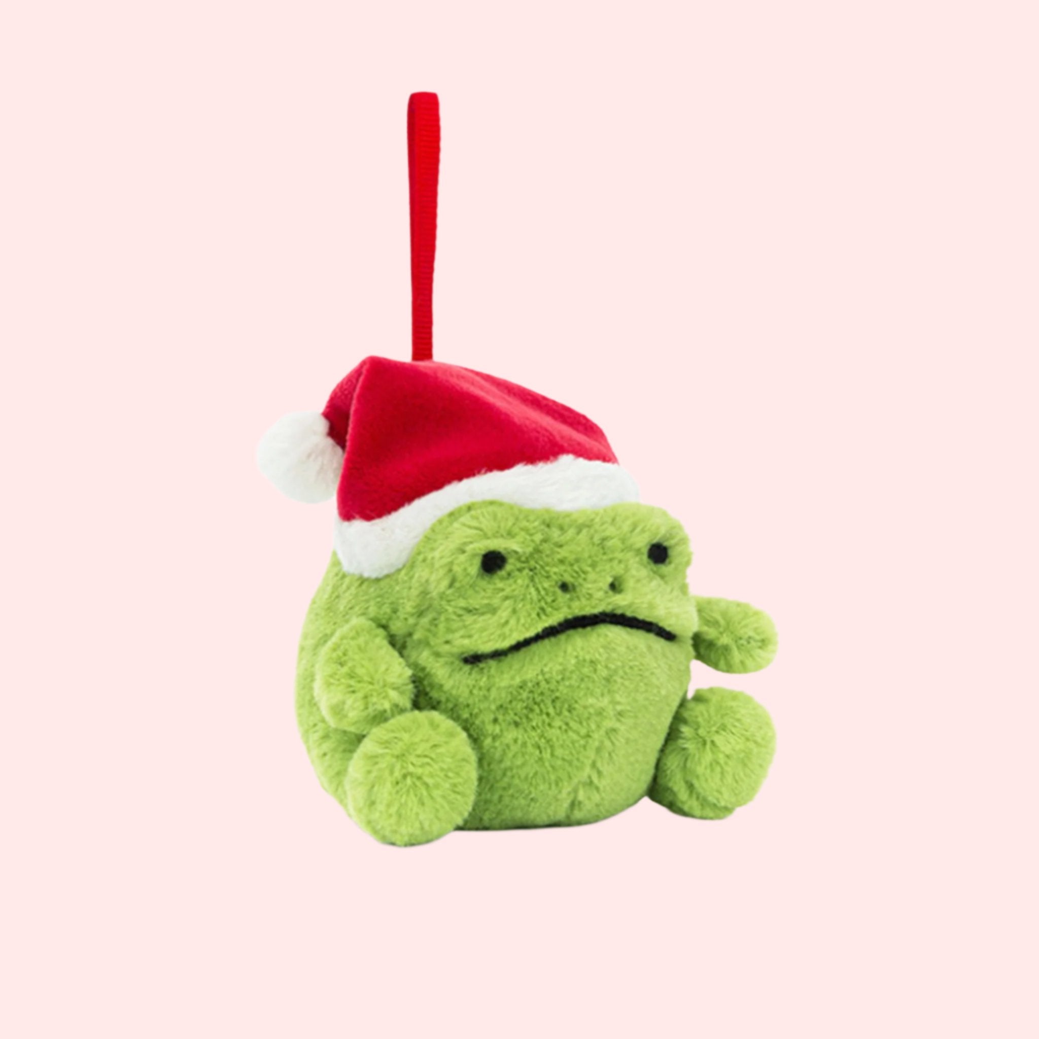 A green frog shaped ornament wearing a red Santa hat. 