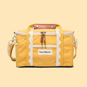 A yellow cooler bag with wavy ivory and yellow handles.