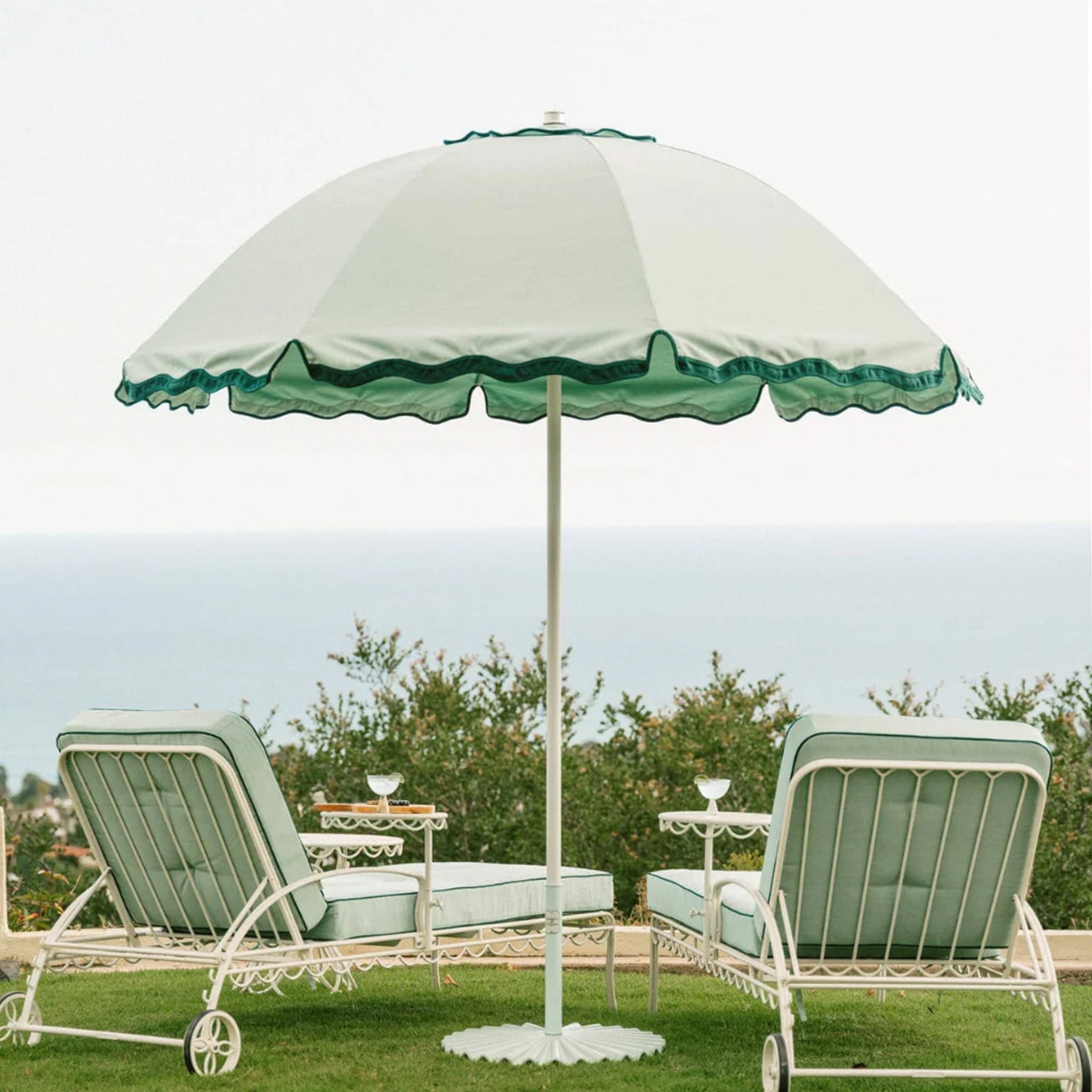 A green lounge cushion with a darker green border around the edges. Lounge chair base and staging props sold separately. 