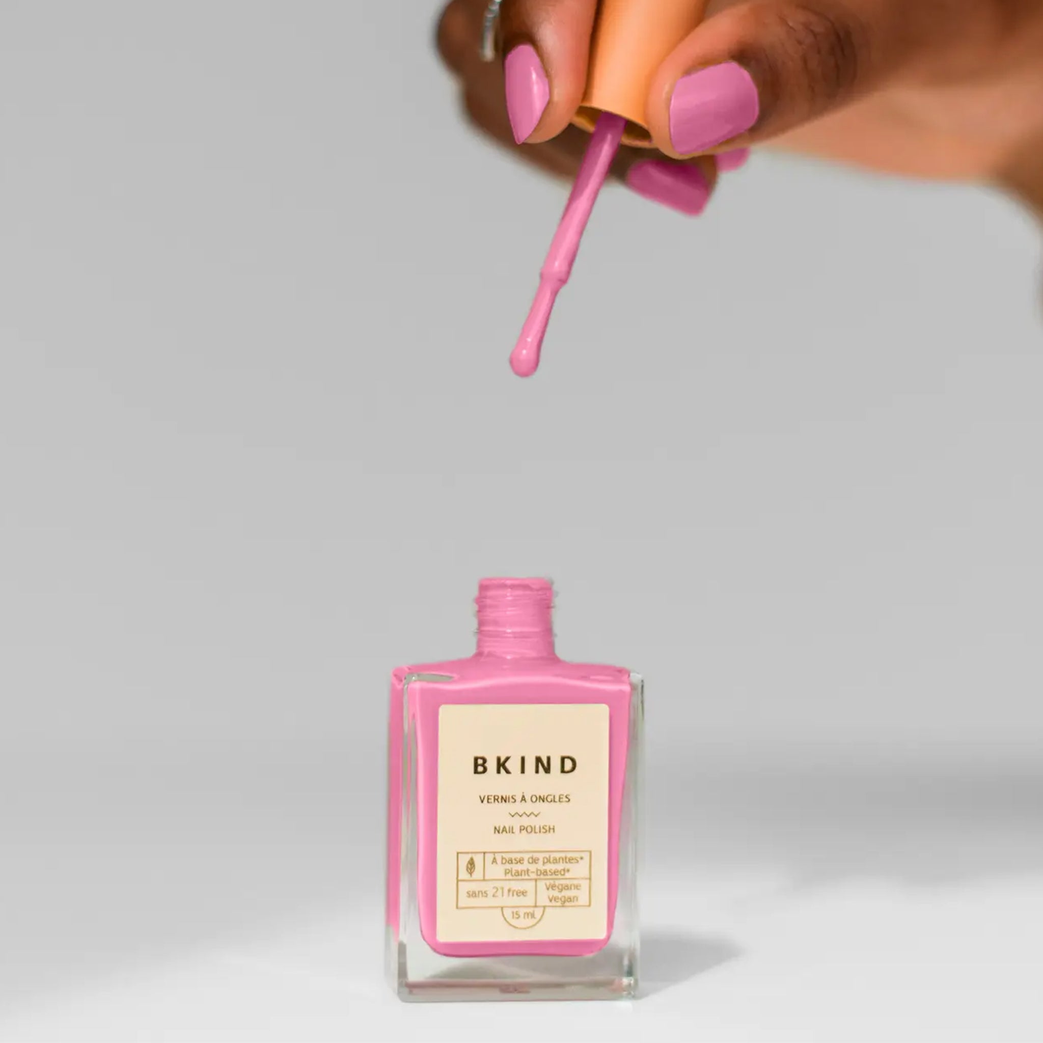 A creamy barbie pink nail polish in a rectangle bottle. 