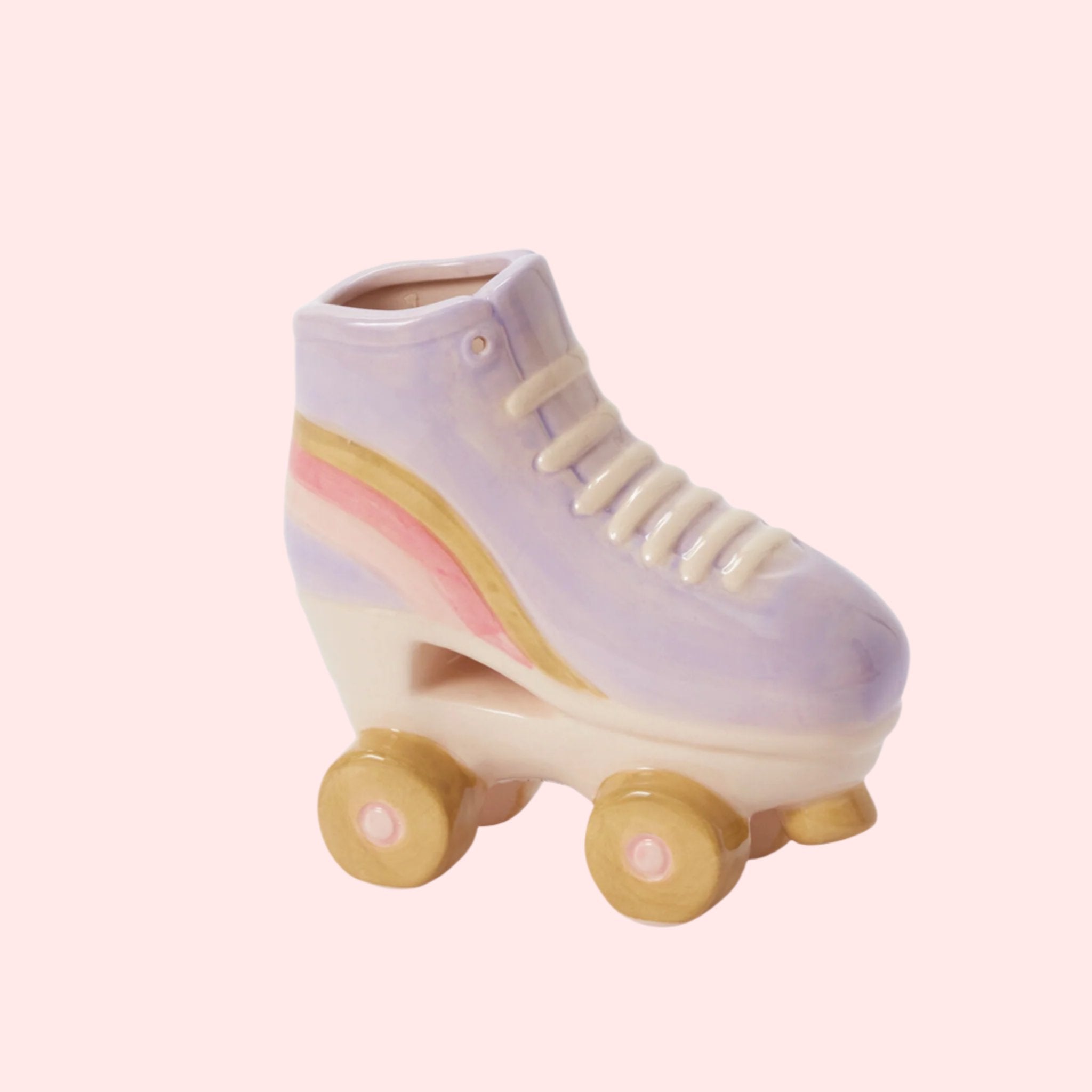 A purple ceramic roller skate shaped planter with yellow and pink details. 