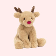 A reindeer shaped stuffed animal toy with a red nose and brown antlers.