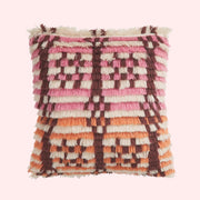 A pink, brown and orange geometric patterned pillow. 